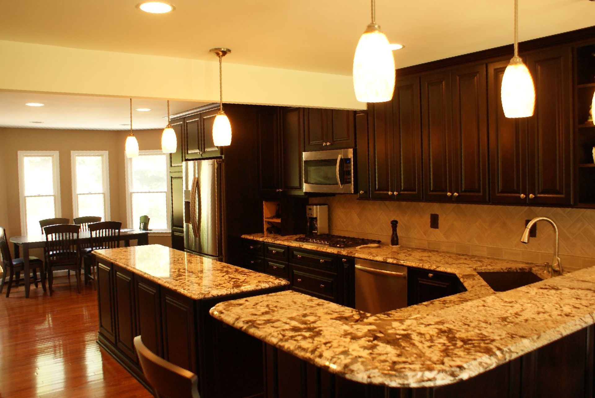 A kitchen with granite counter tops and stainless steel appliances