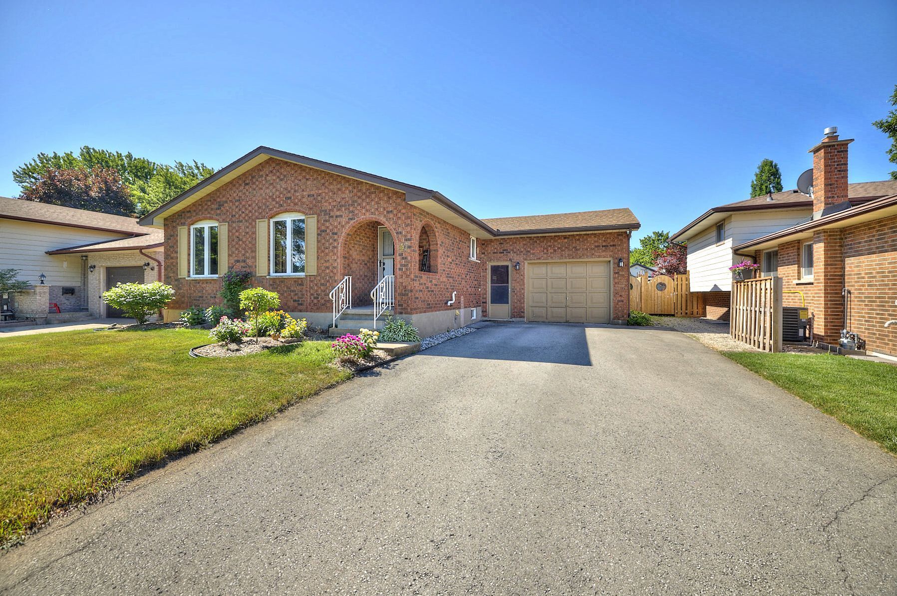 A dream home set amidst a scenic landscape of trees and a bright blue sky.