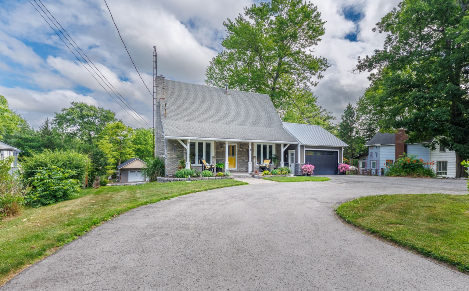 A detached home with an attached garage and a detached garage in Wainfleet.