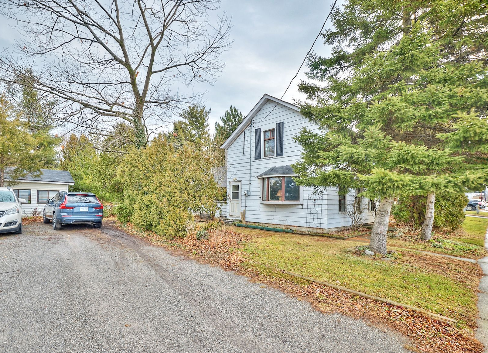 A 1 1/2 storey home with a detached oversized shed.