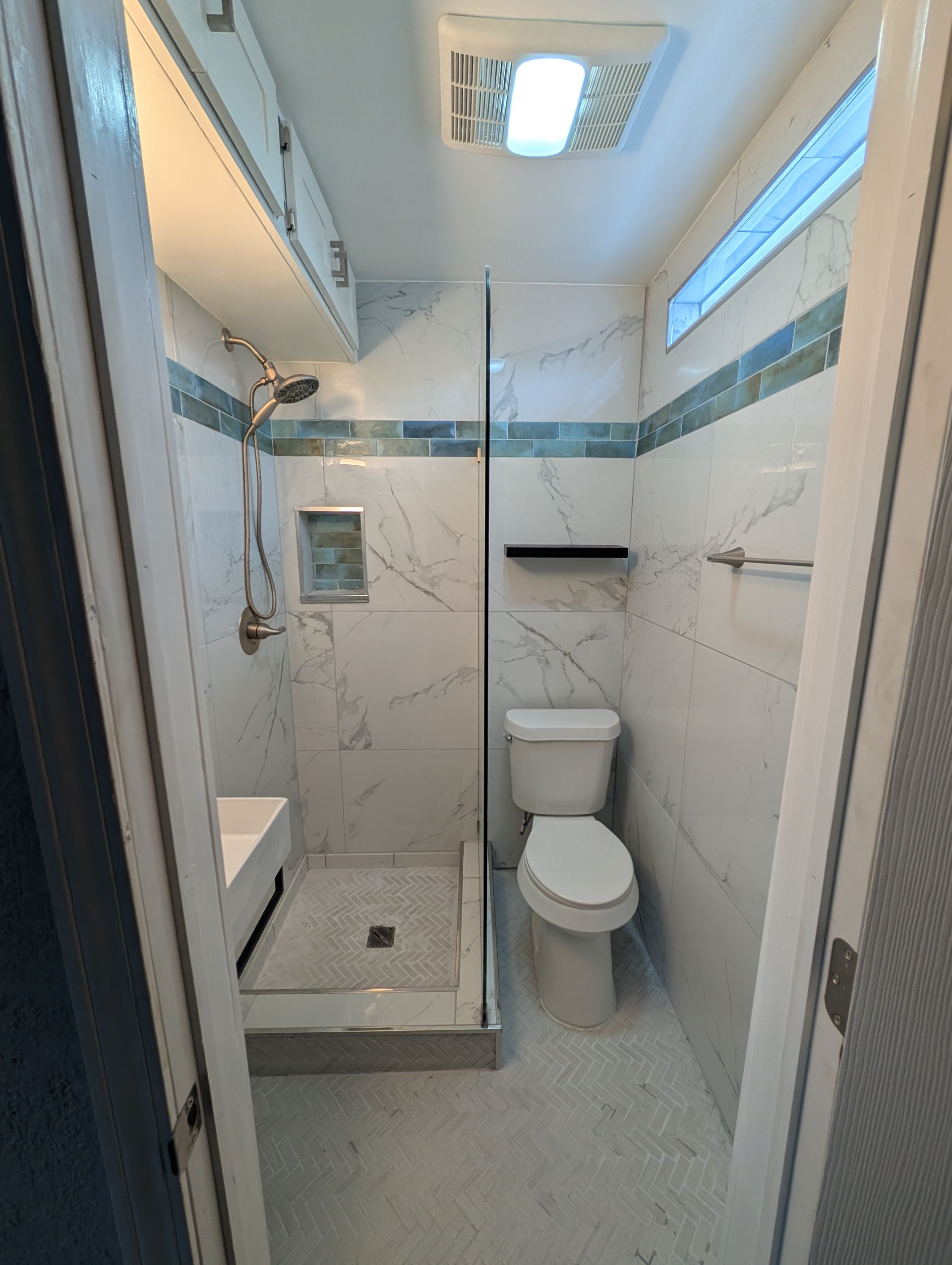 Aarons Repair and Remodel - A bathroom with a toilet , sink and shower.
