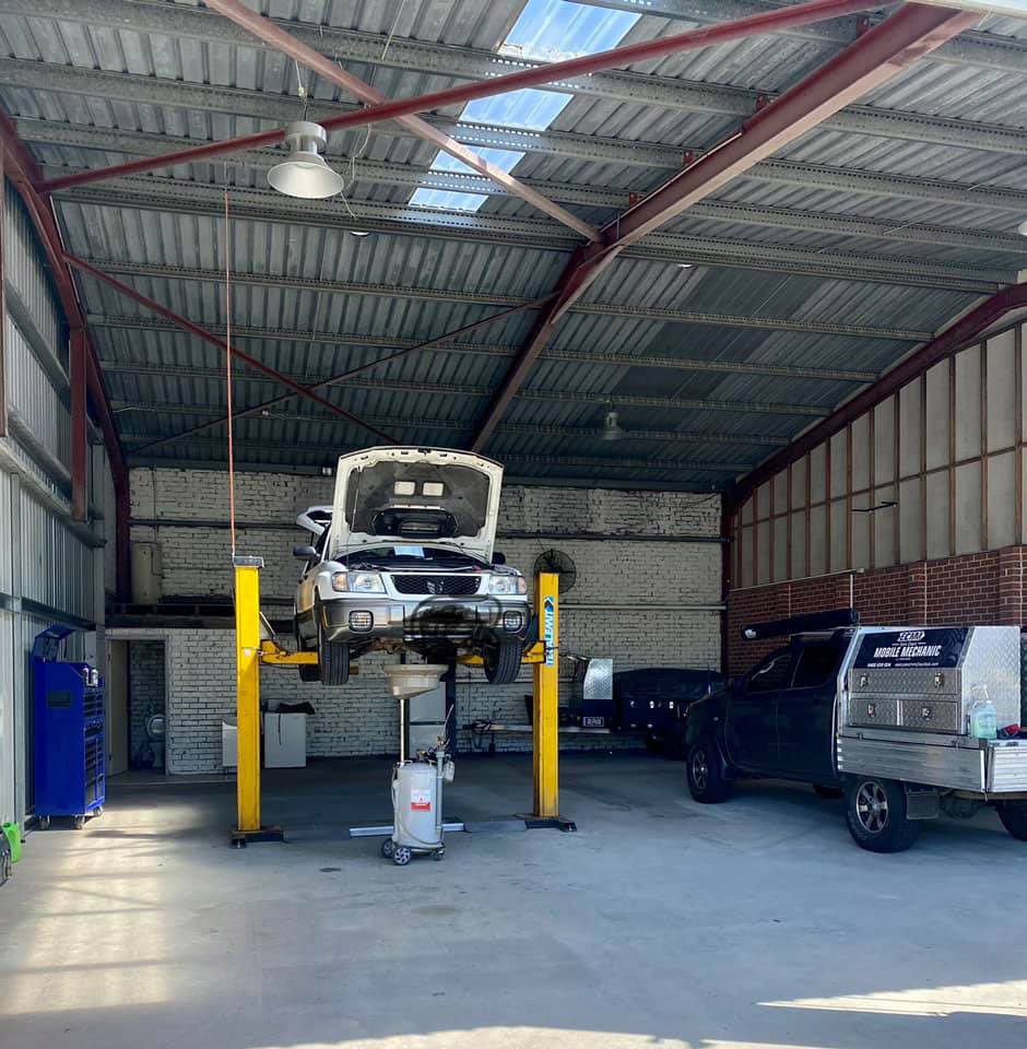 Car Workshop with a Car on a Stand — East Coast Mechanic in Nambucca Heads, NSW