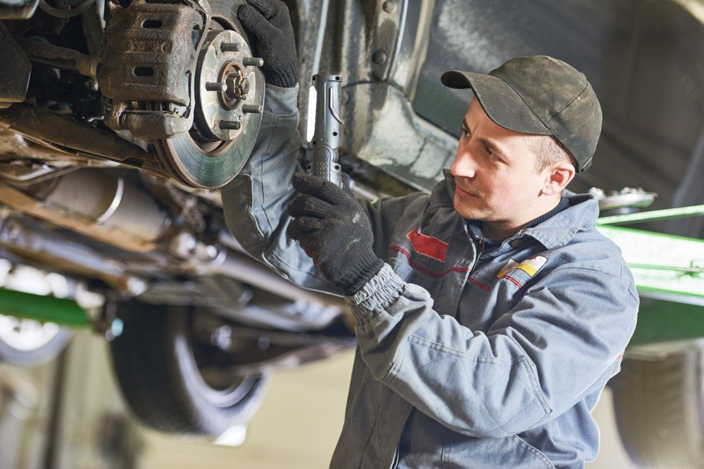 Mechanic Inspecting Car Suspension — East Coast Mechanic in Nambucca Heads, NSW