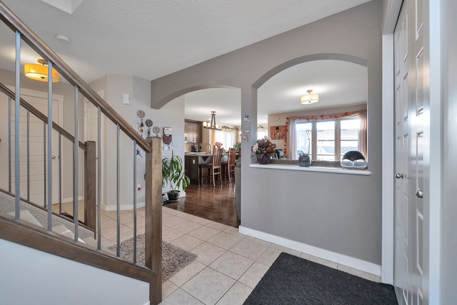 A hallway with stairs leading up to the second floor of a house