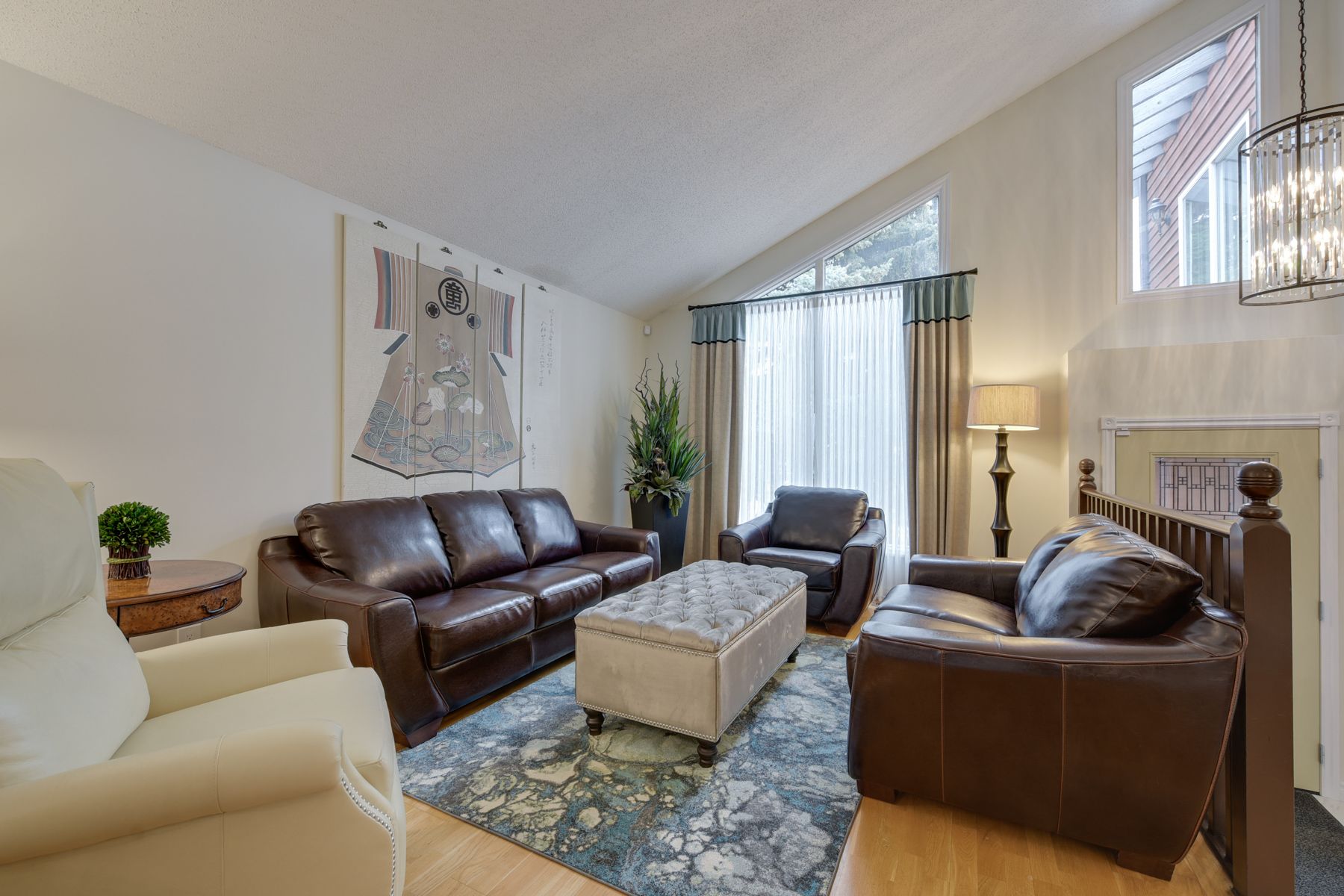 A living room filled with furniture and a large window.