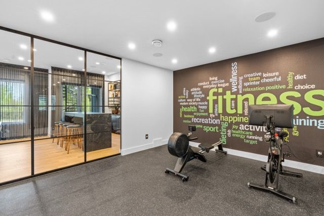 A gym with a wall that says fitness on it