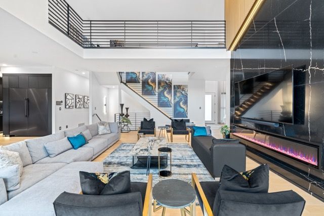 A living room with a lot of furniture and a fireplace