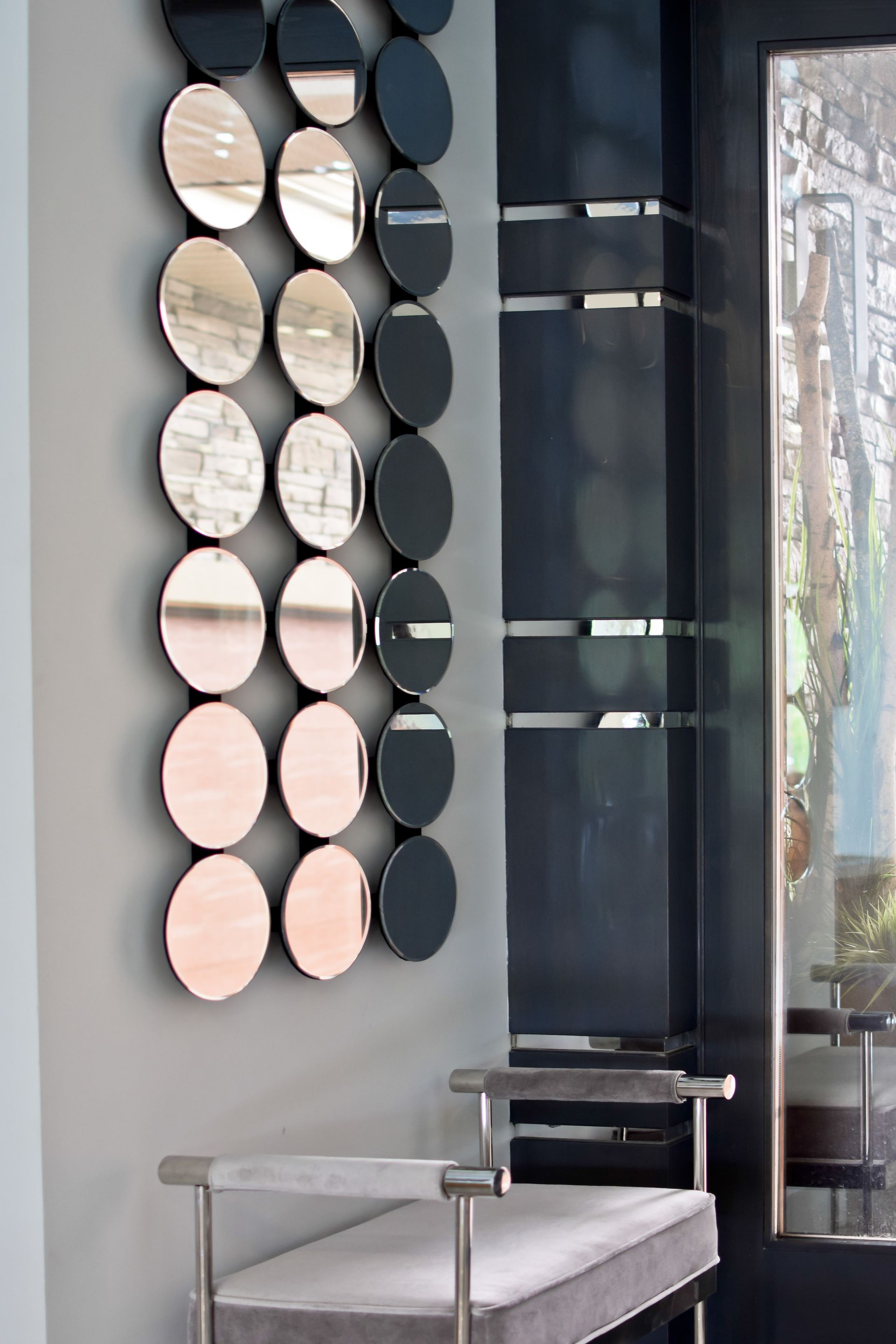 A room with a bench and a mirror on the wall