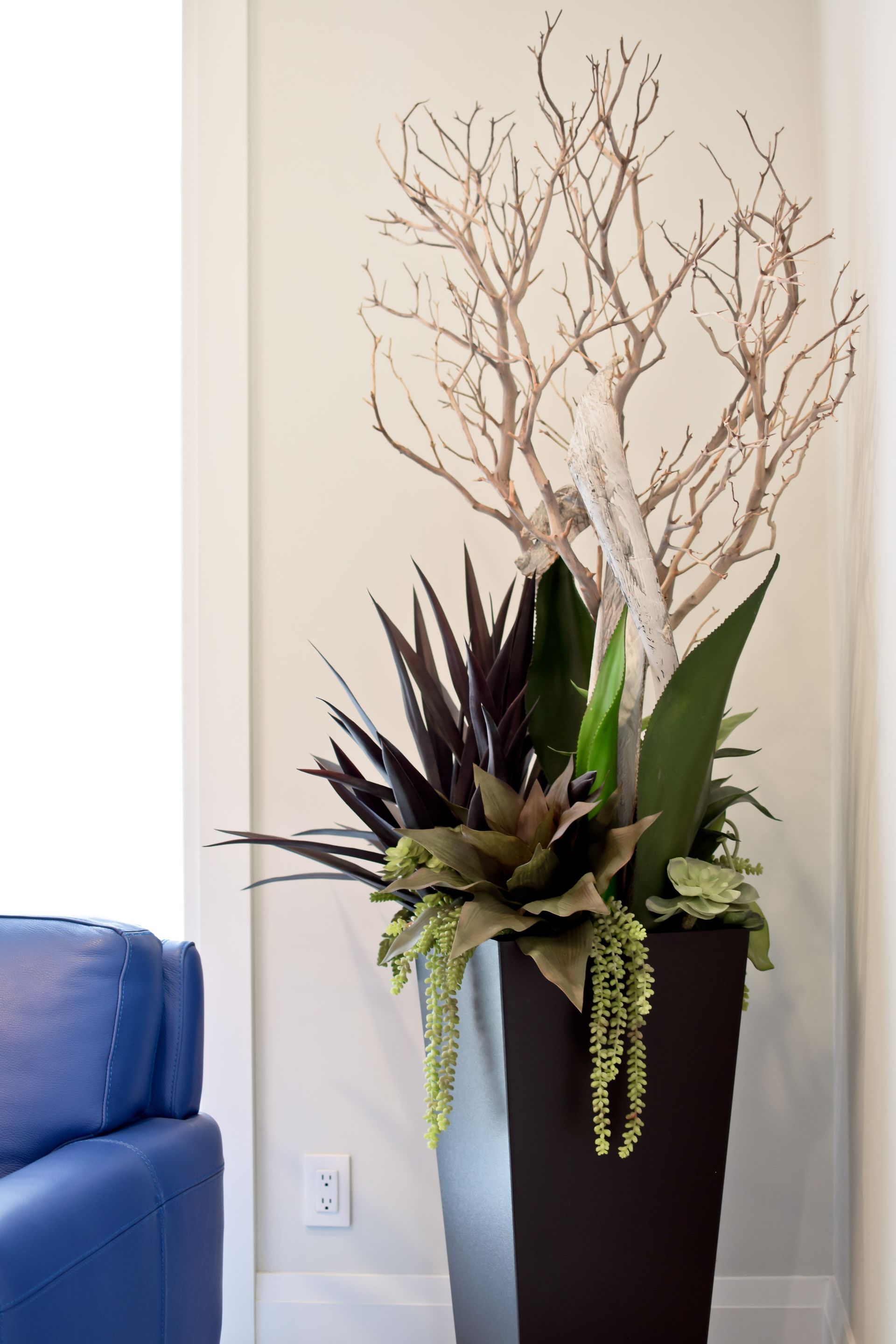 A large potted plant with a tree in it