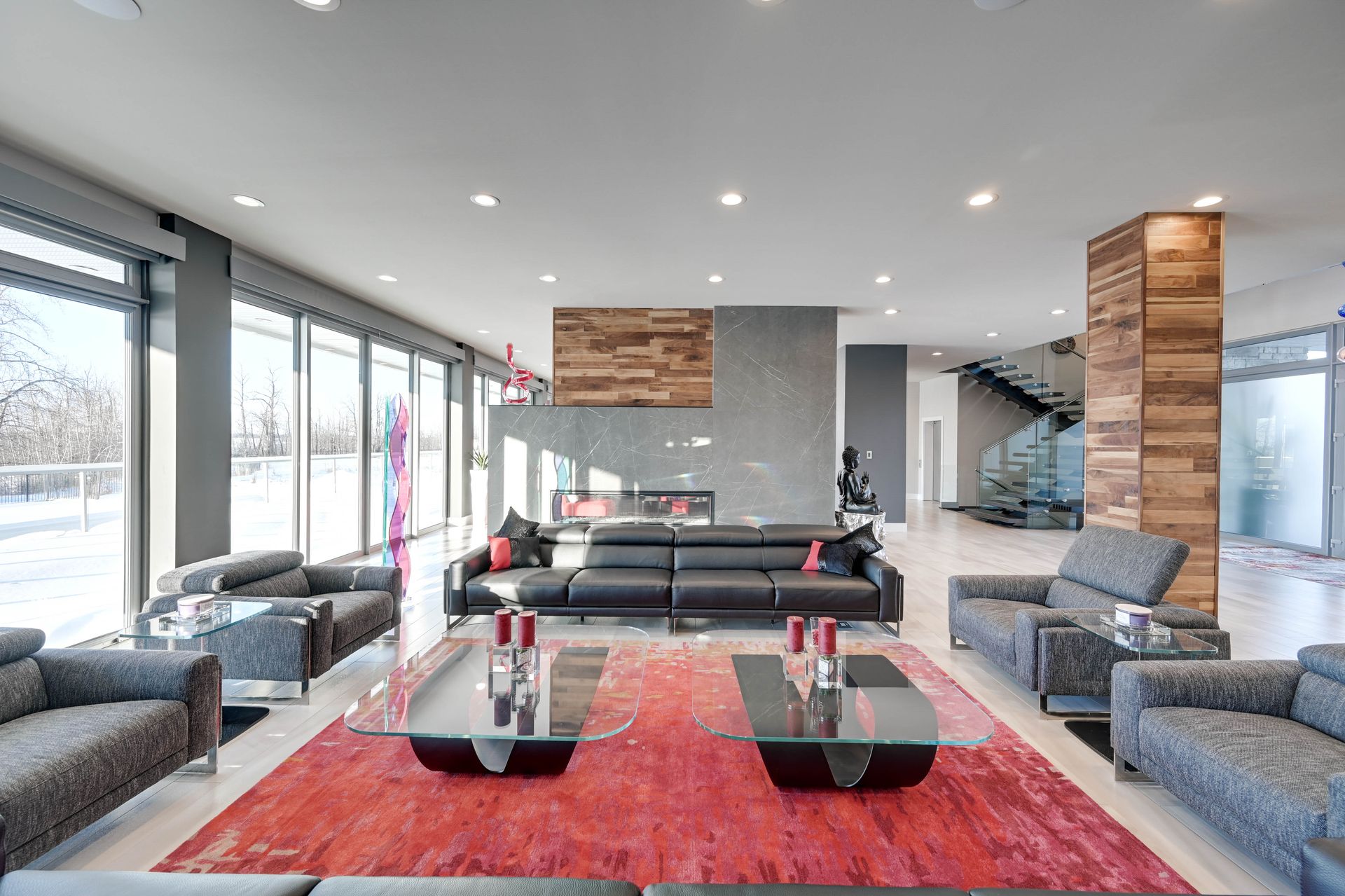 A living room with a lot of furniture and a red rug