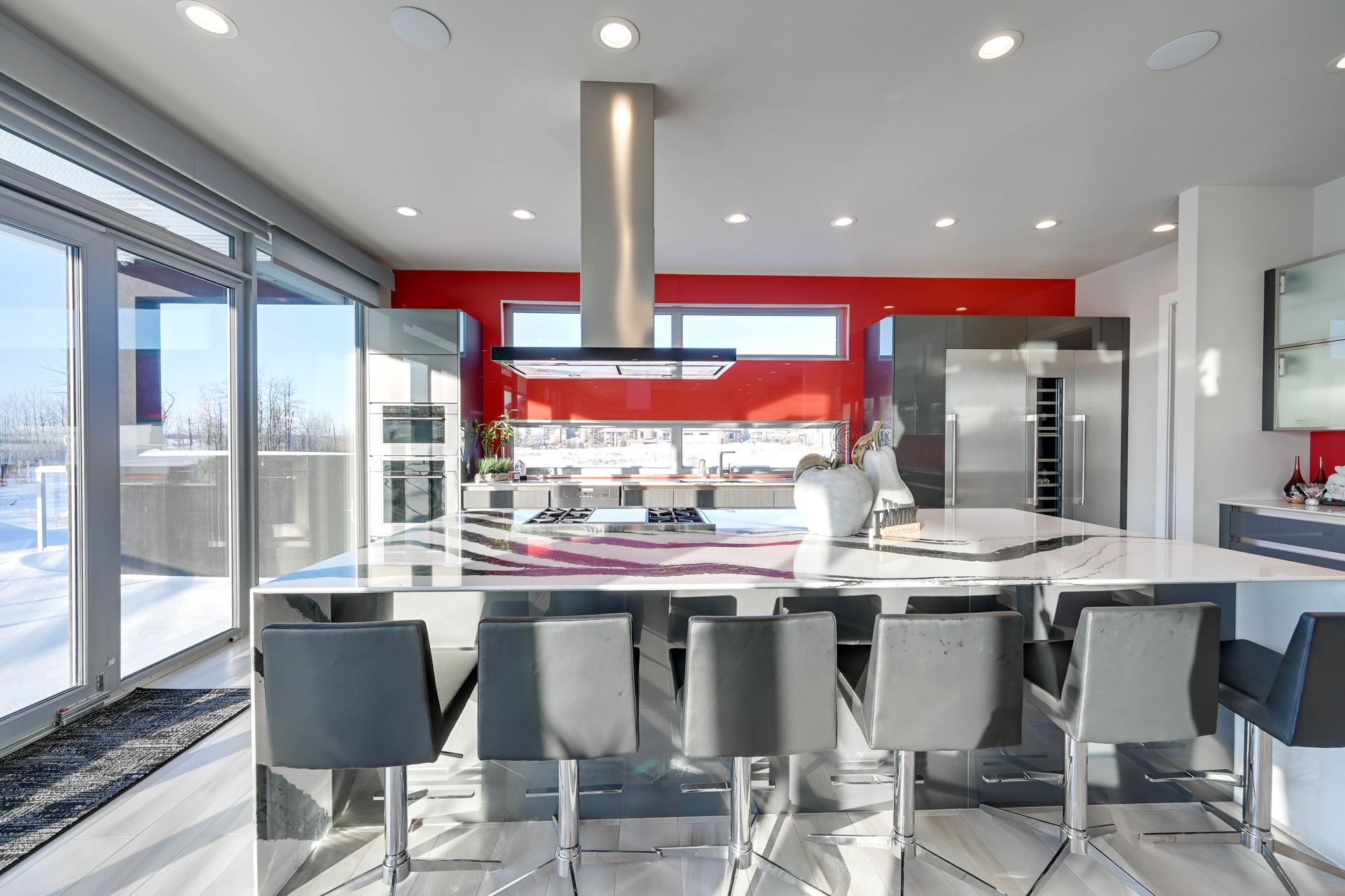 A kitchen with a large island and stainless steel appliances