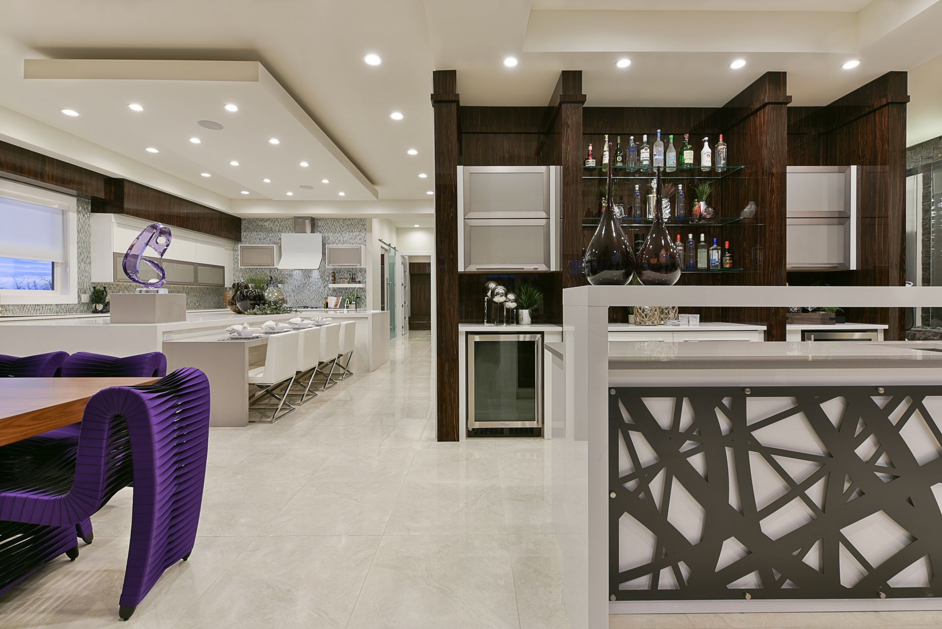 A large room with a dining table and chairs and a bar.