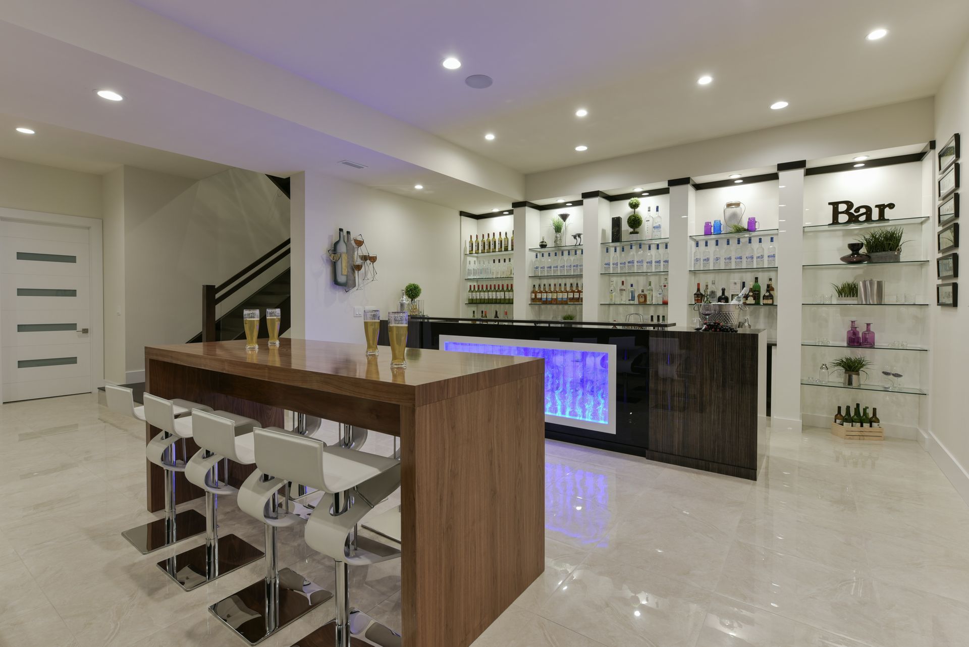 A bar in a basement with a long table and stools