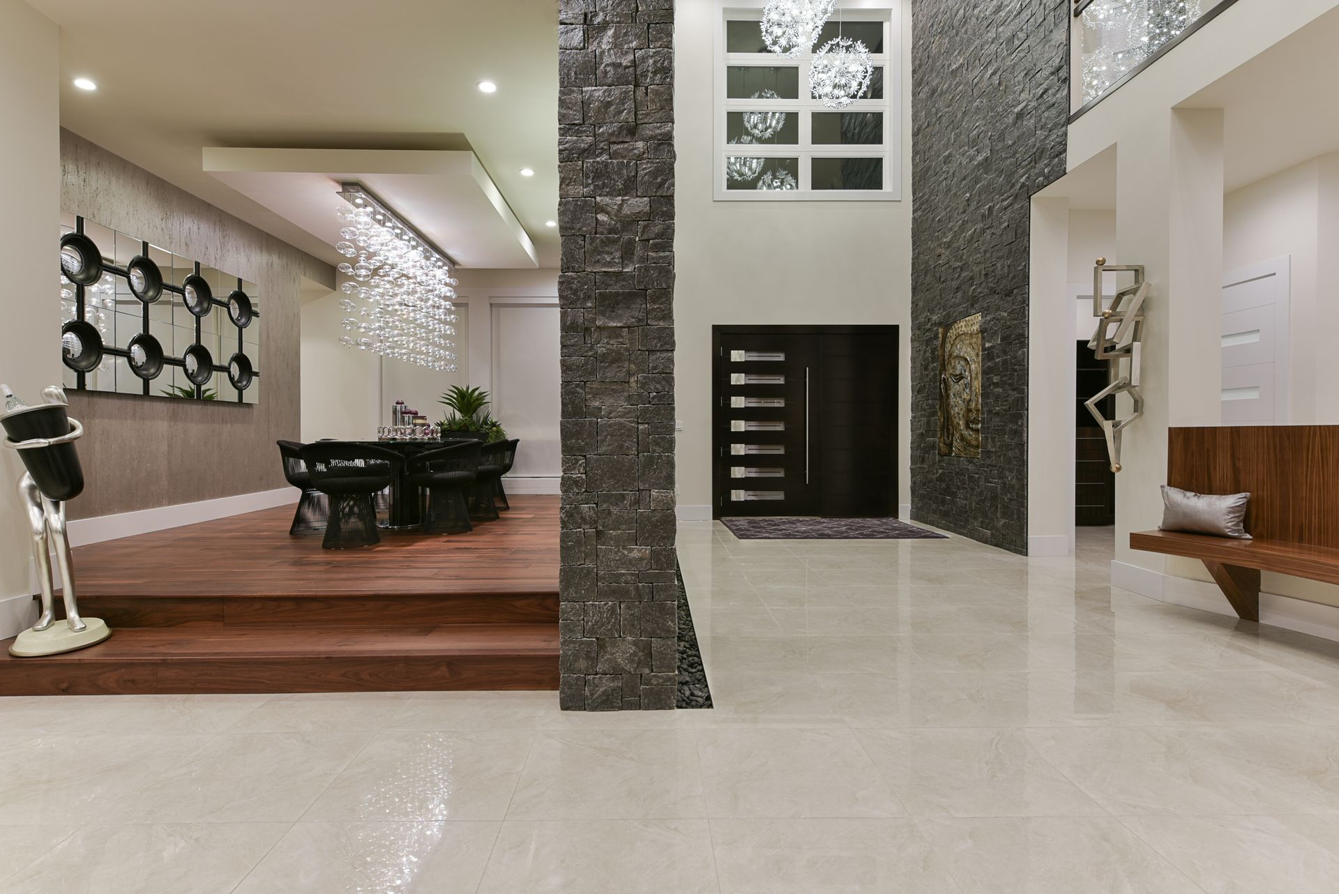 A large hallway in a house with a dining room and stairs