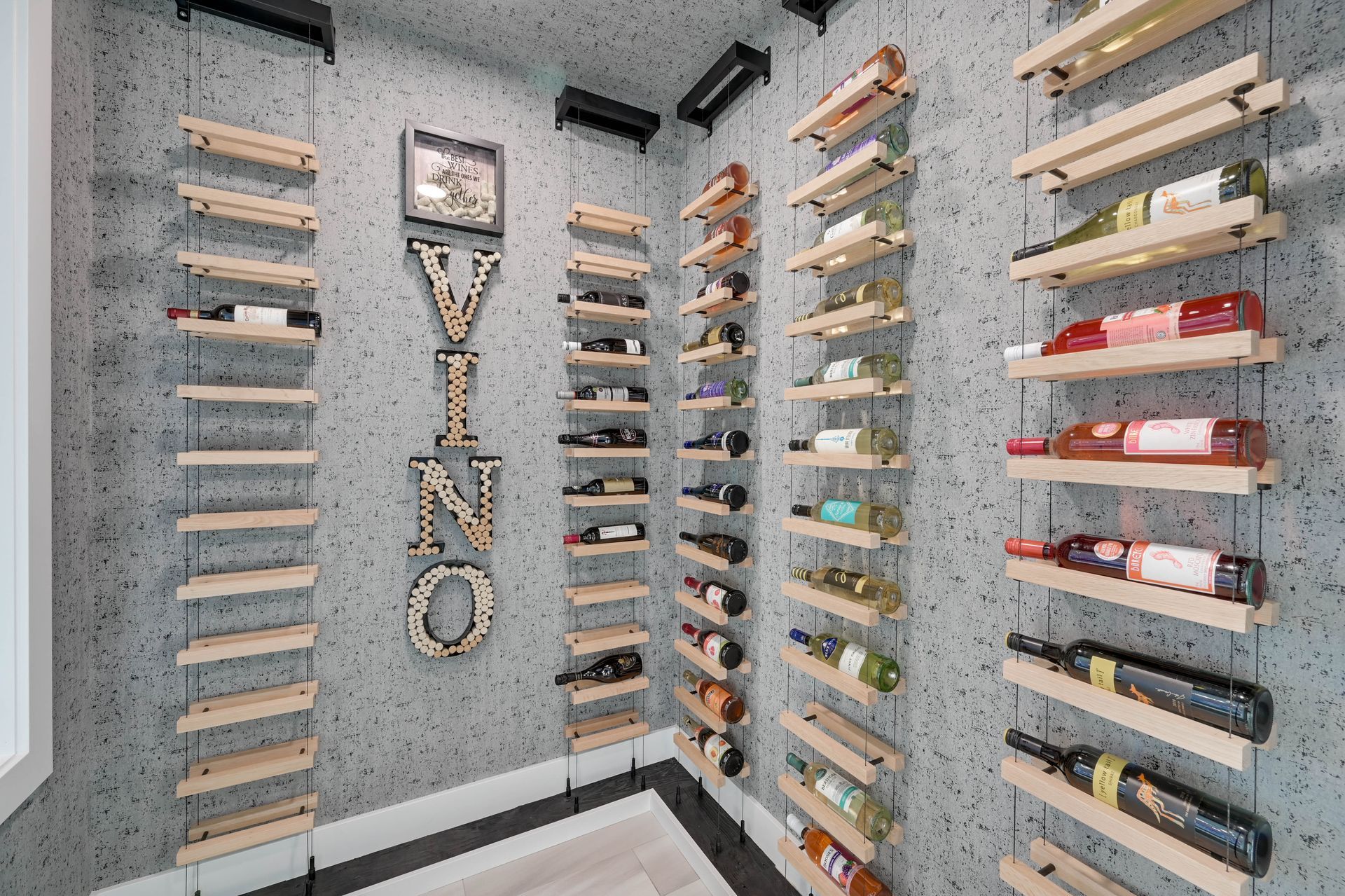 A wine cellar with wooden shelves filled with bottles of wine.