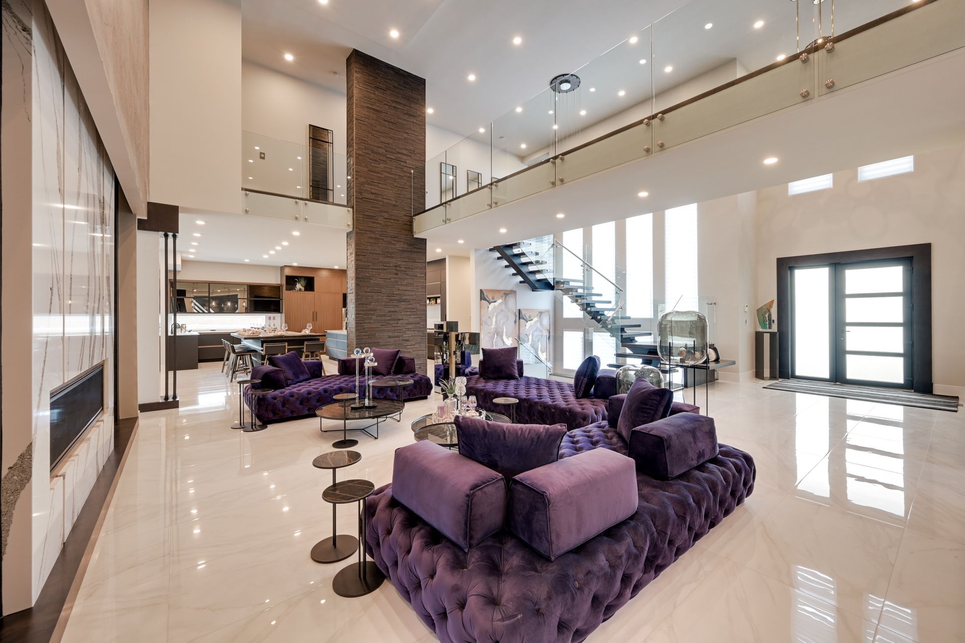 There is a purple couch in the middle of the living room.