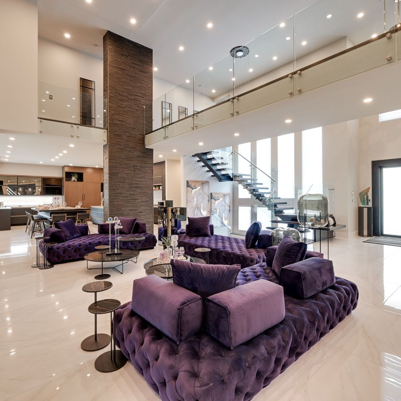A living room with purple furniture and a staircase