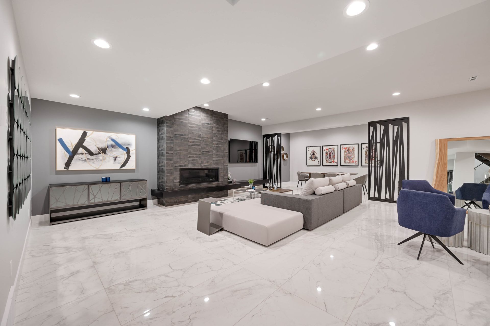 A living room with a couch , chairs , and a fireplace.