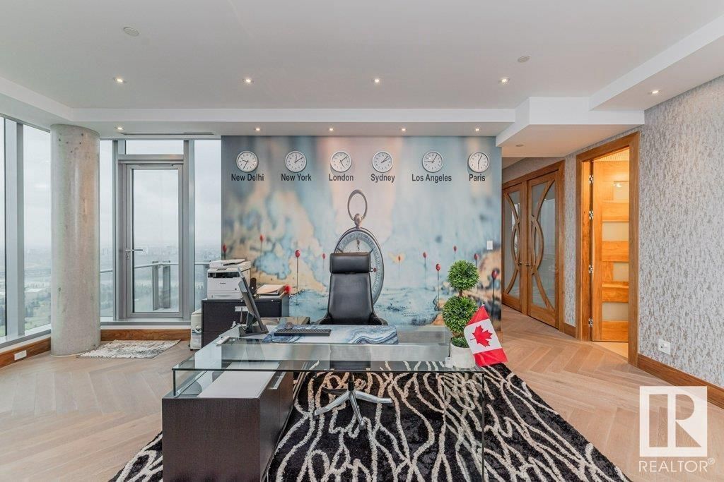 A large room with a desk and a clock on the wall.