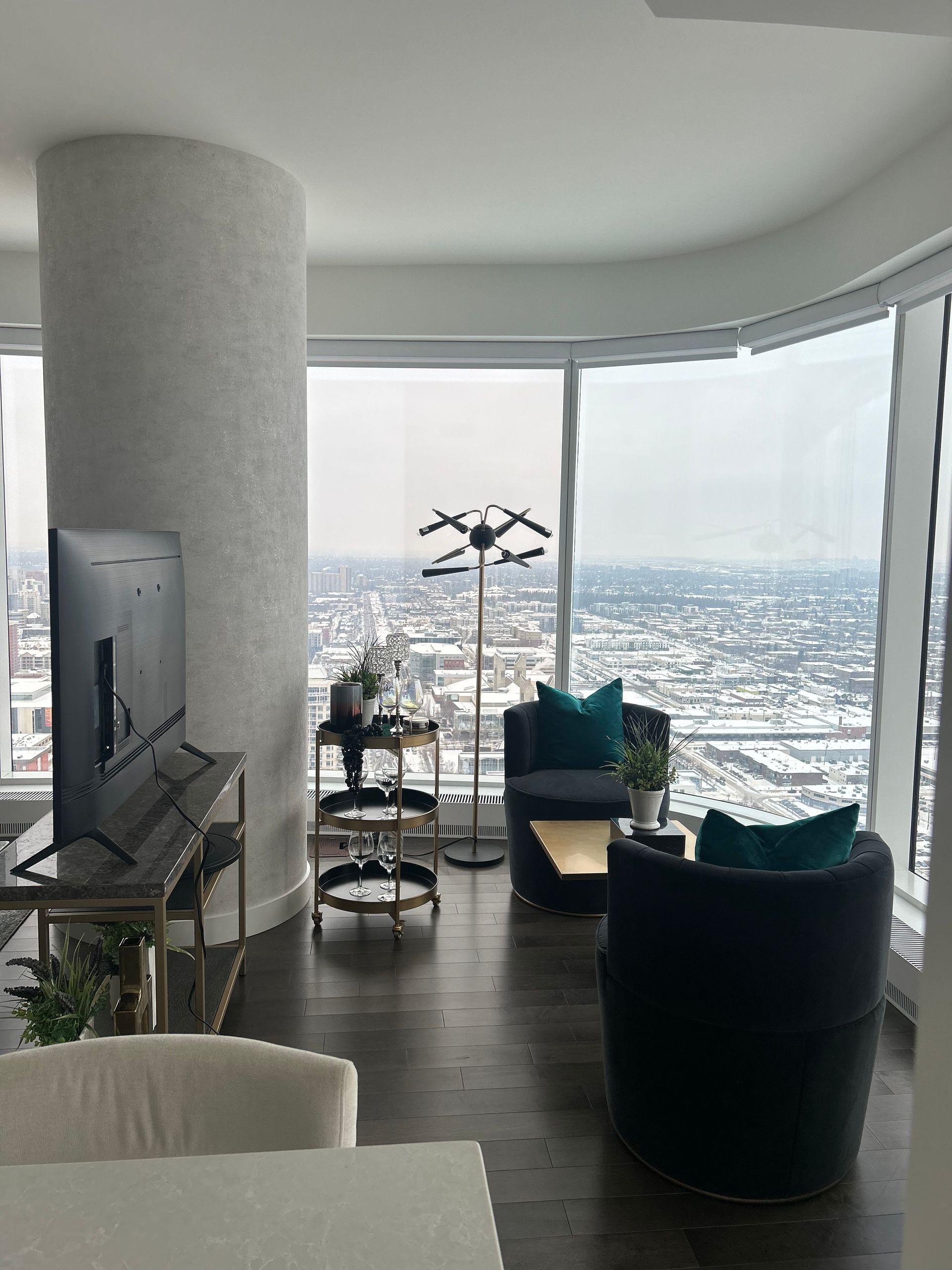 A living room with a large window and a flat screen tv.