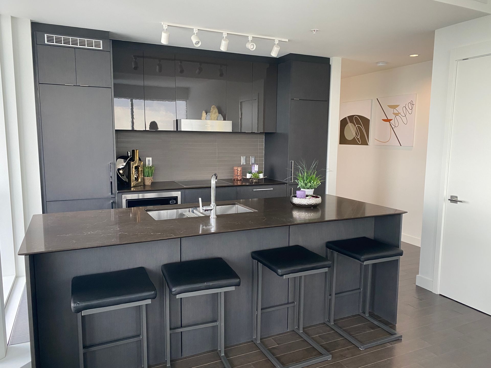 A kitchen with a large island and stools
