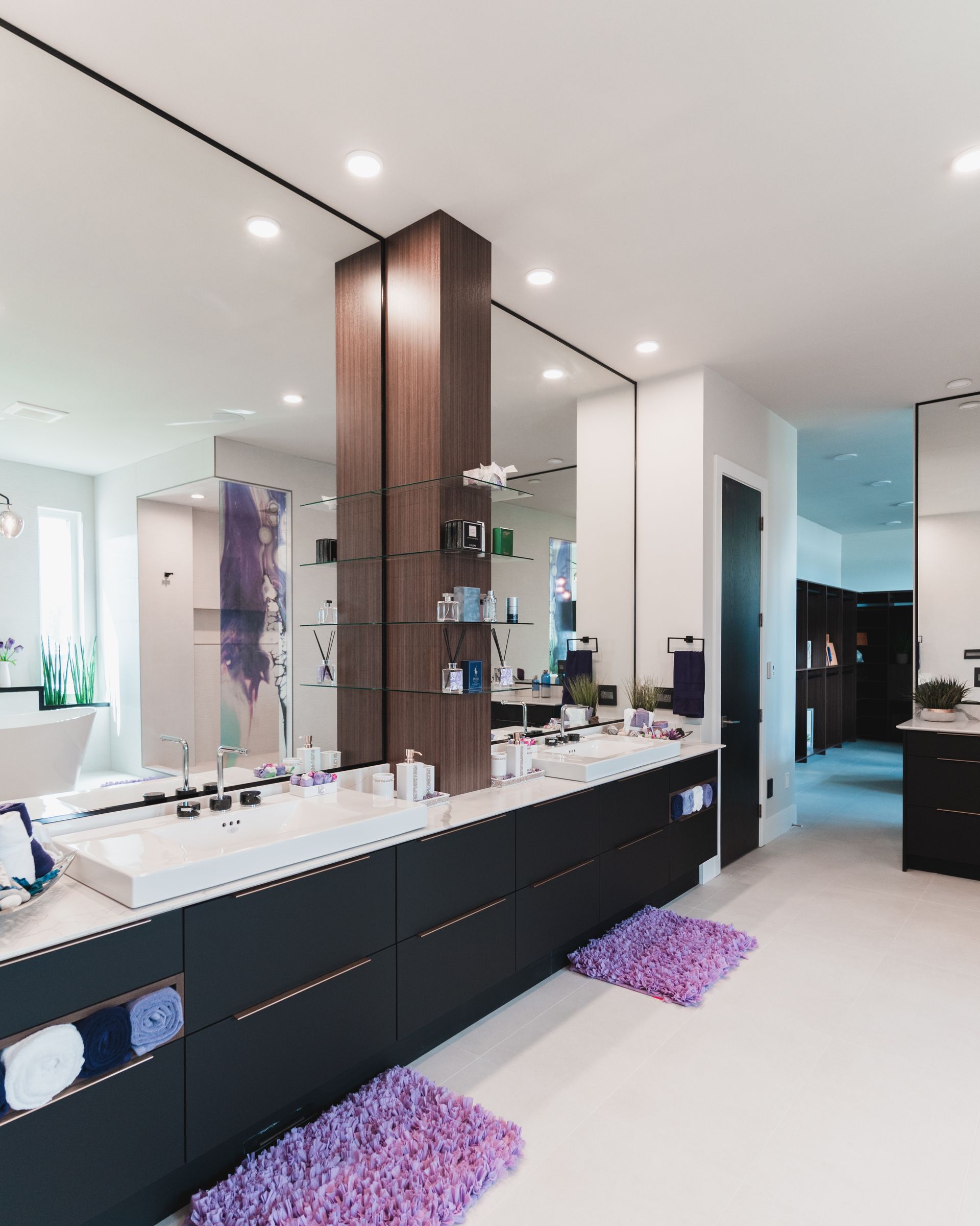 A bathroom with two sinks and a large mirror
