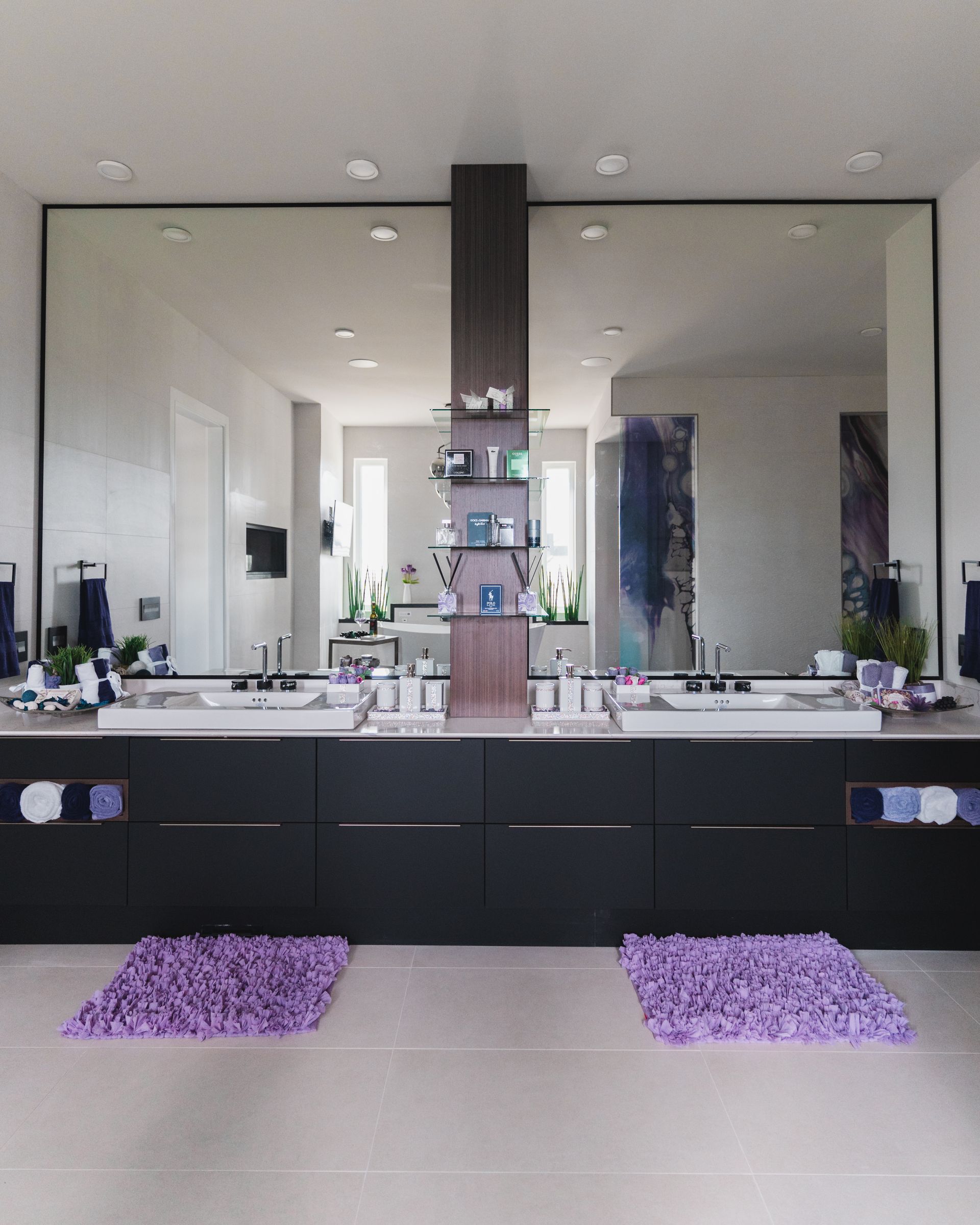A bathroom with two sinks and a large mirror