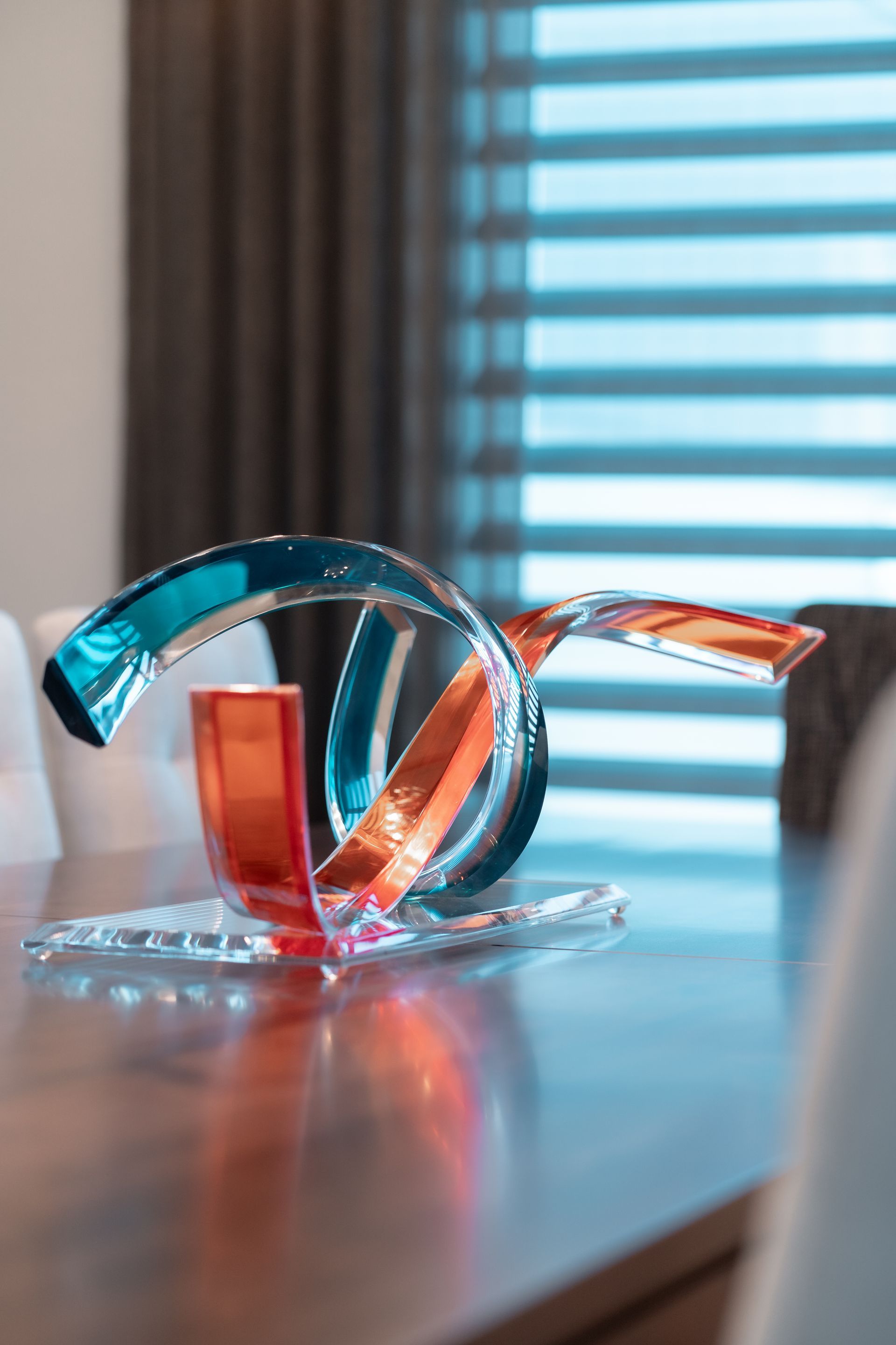 A glass sculpture is sitting on a dining room table.