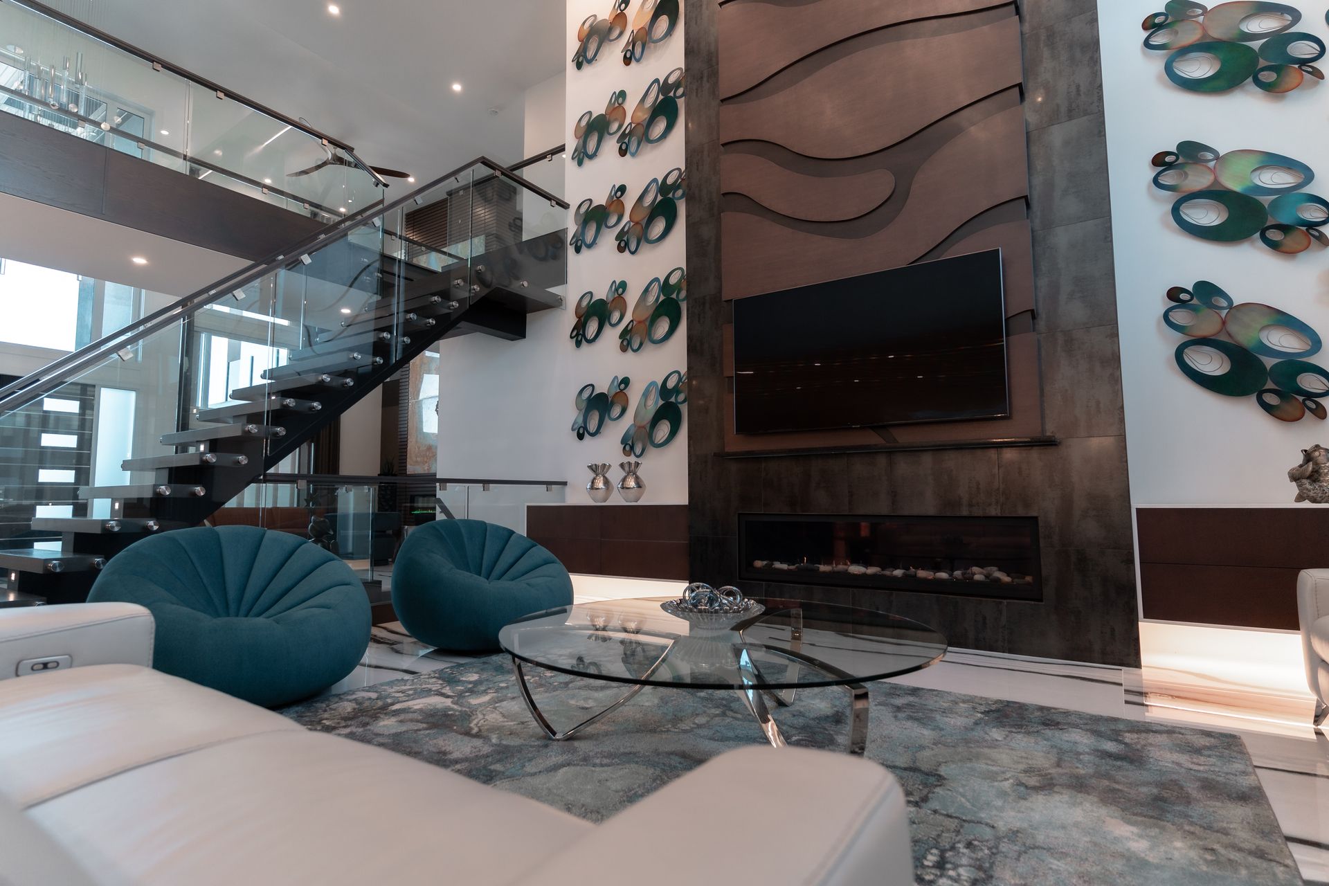 A living room with a couch , chairs , coffee table and television