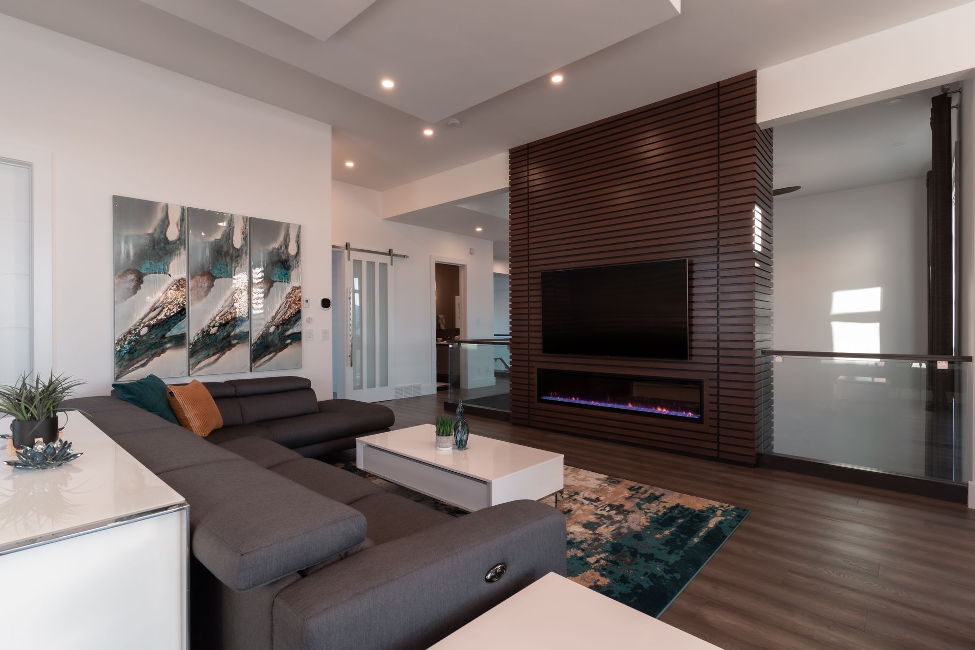 A living room with a couch , coffee table , television and fireplace.