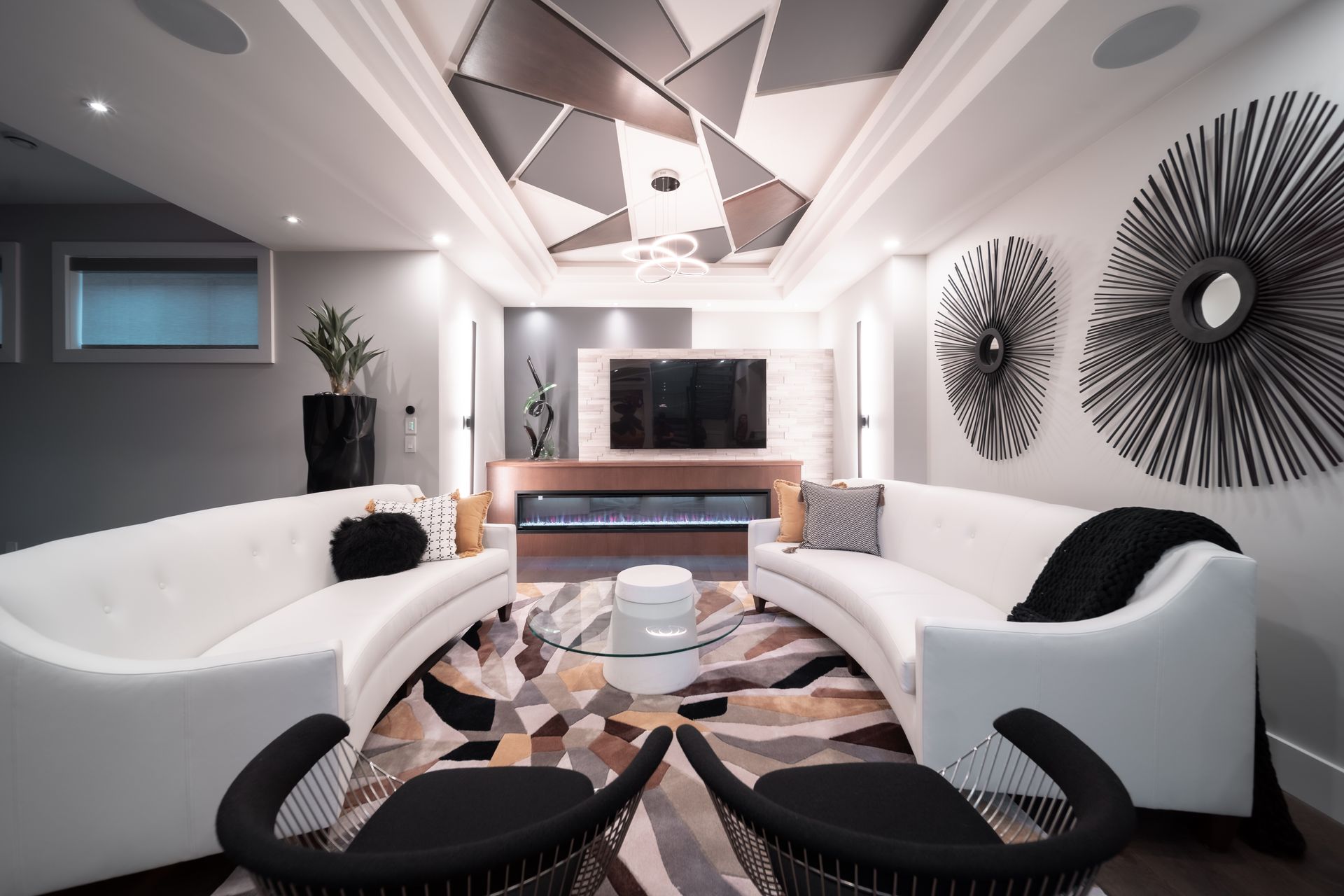 A living room with a curved couch and a flat screen tv