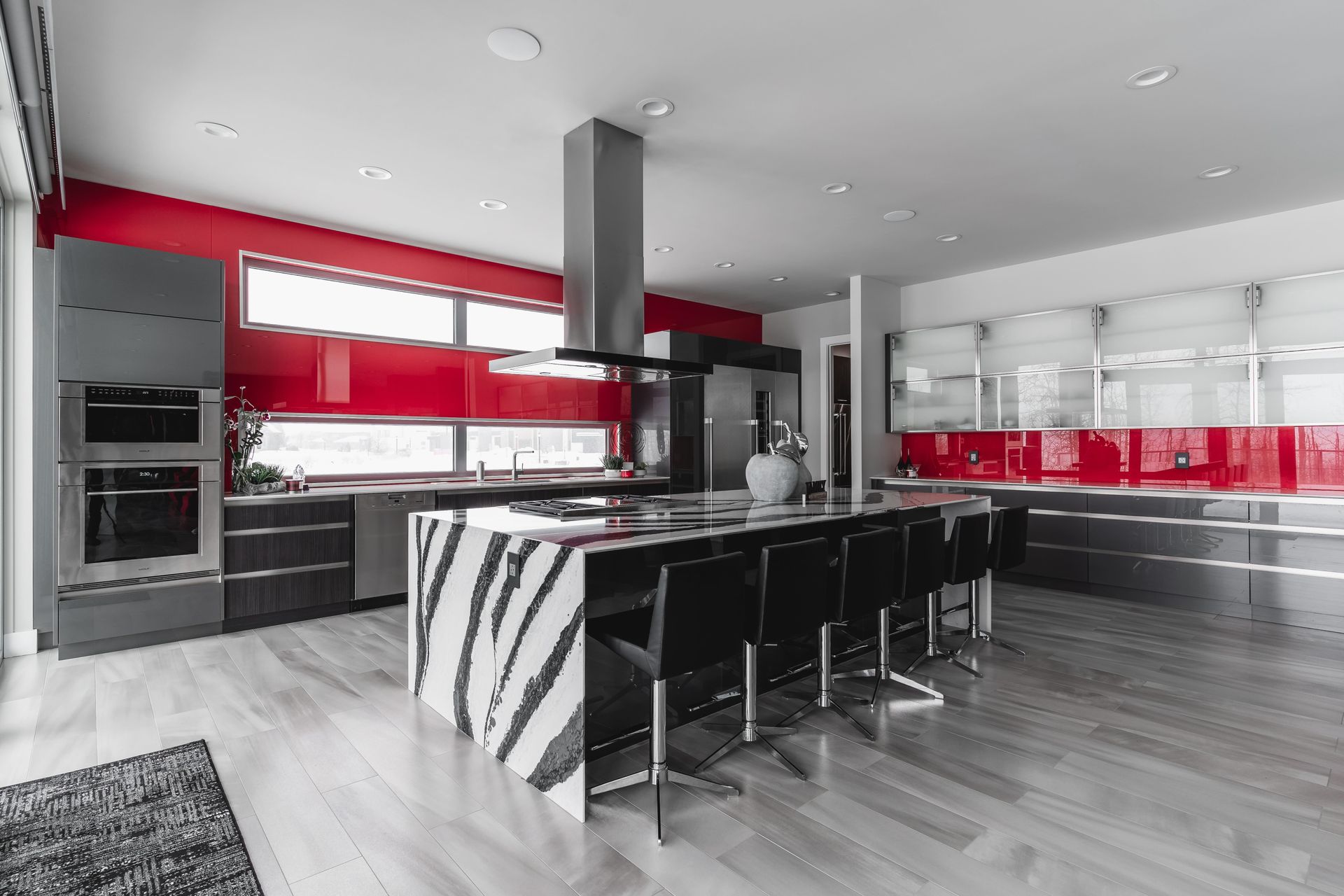 A black and white photo of a kitchen with a large island.