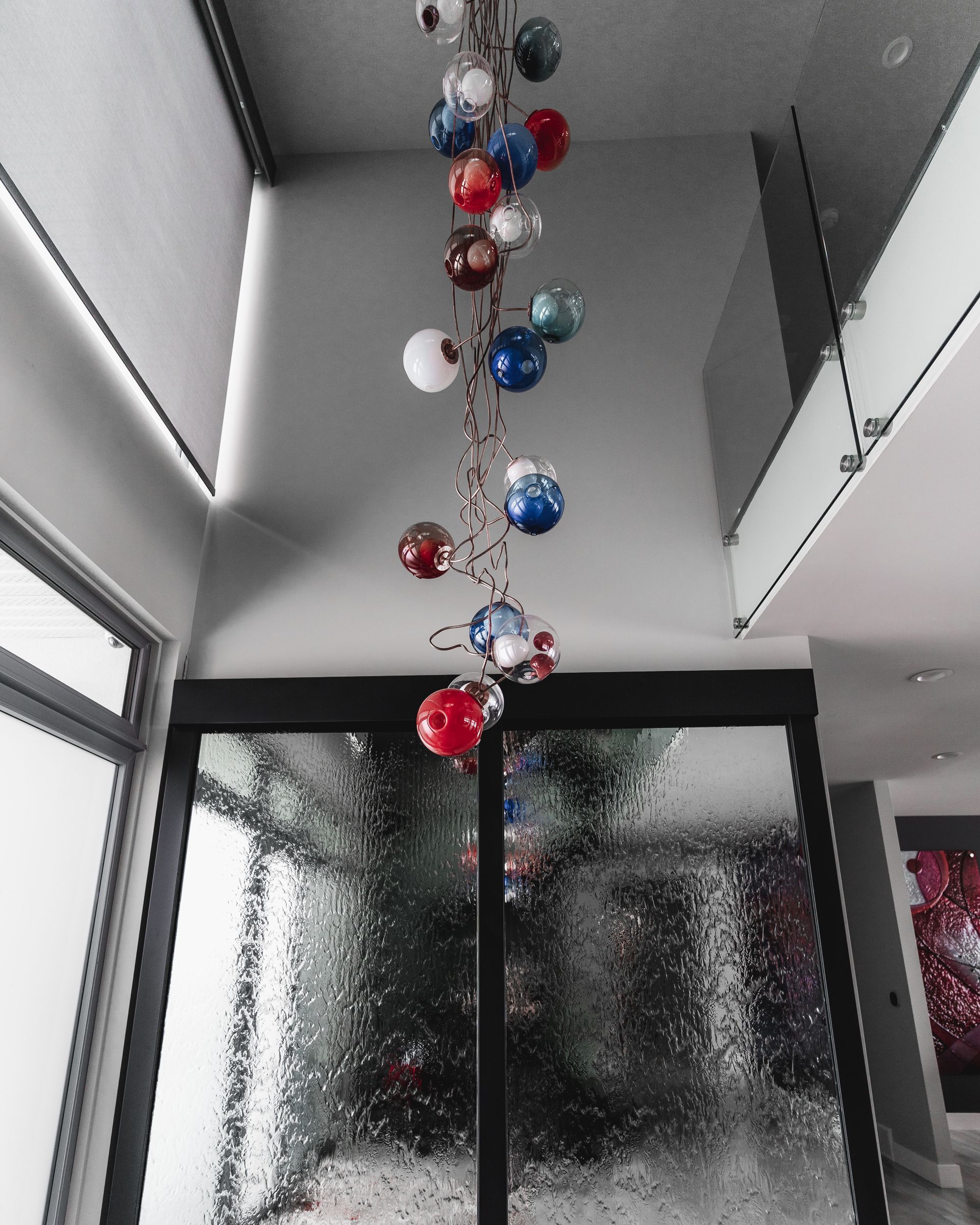 A bunch of balloons are hanging from the ceiling