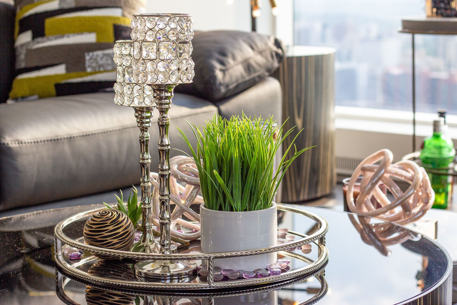 A living room with a couch and a coffee table with a plant on it.