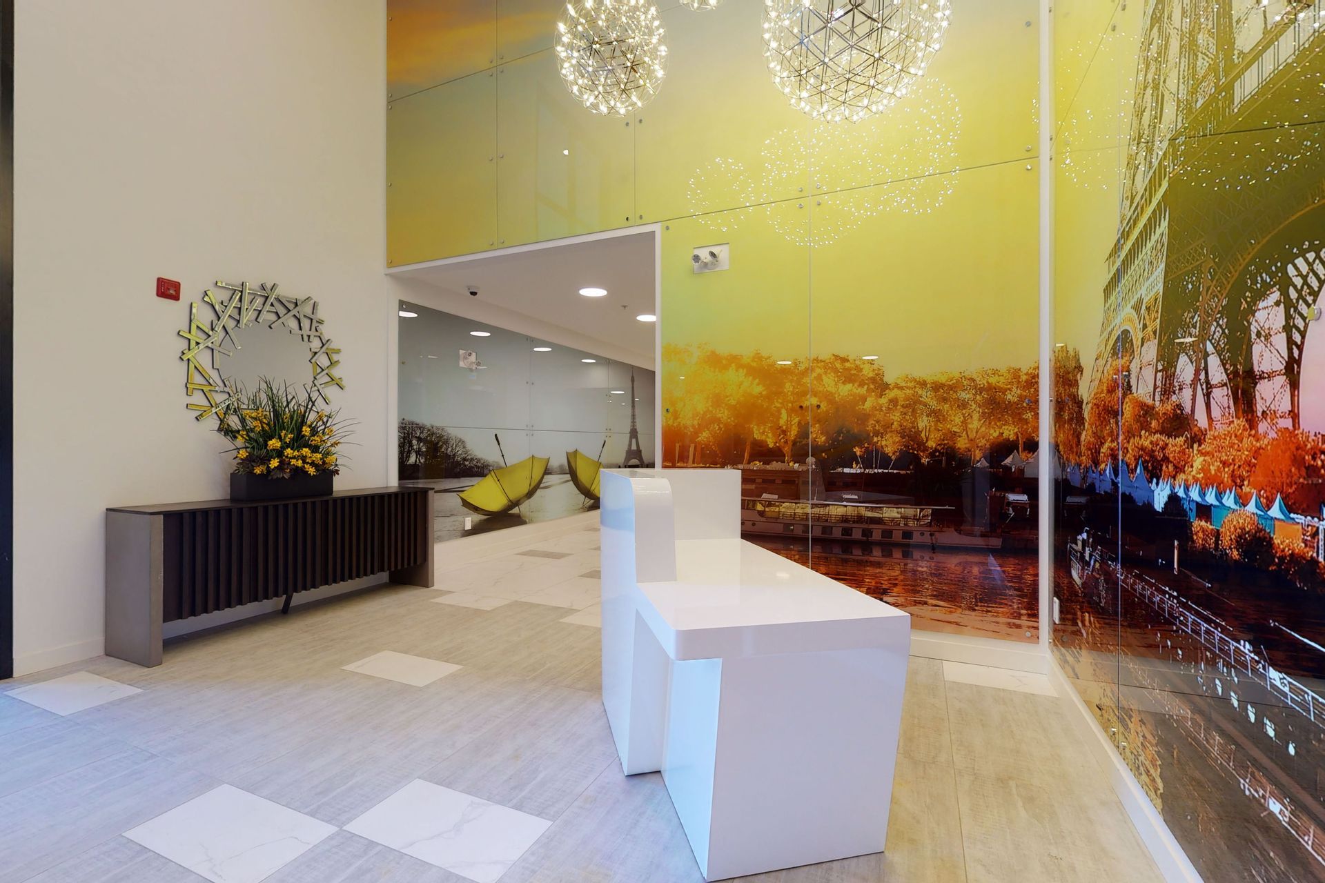 A lobby with a white counter and a picture on the wall.