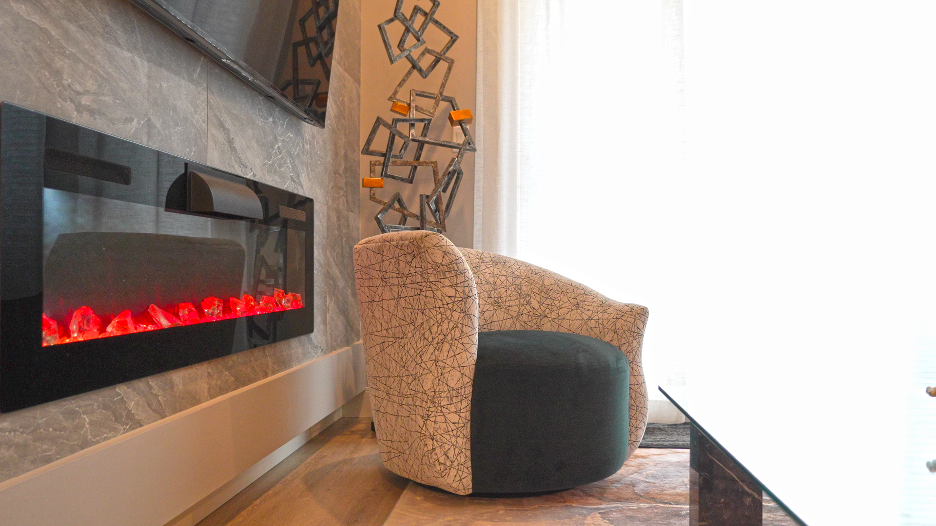 A living room with a fireplace and a chair.