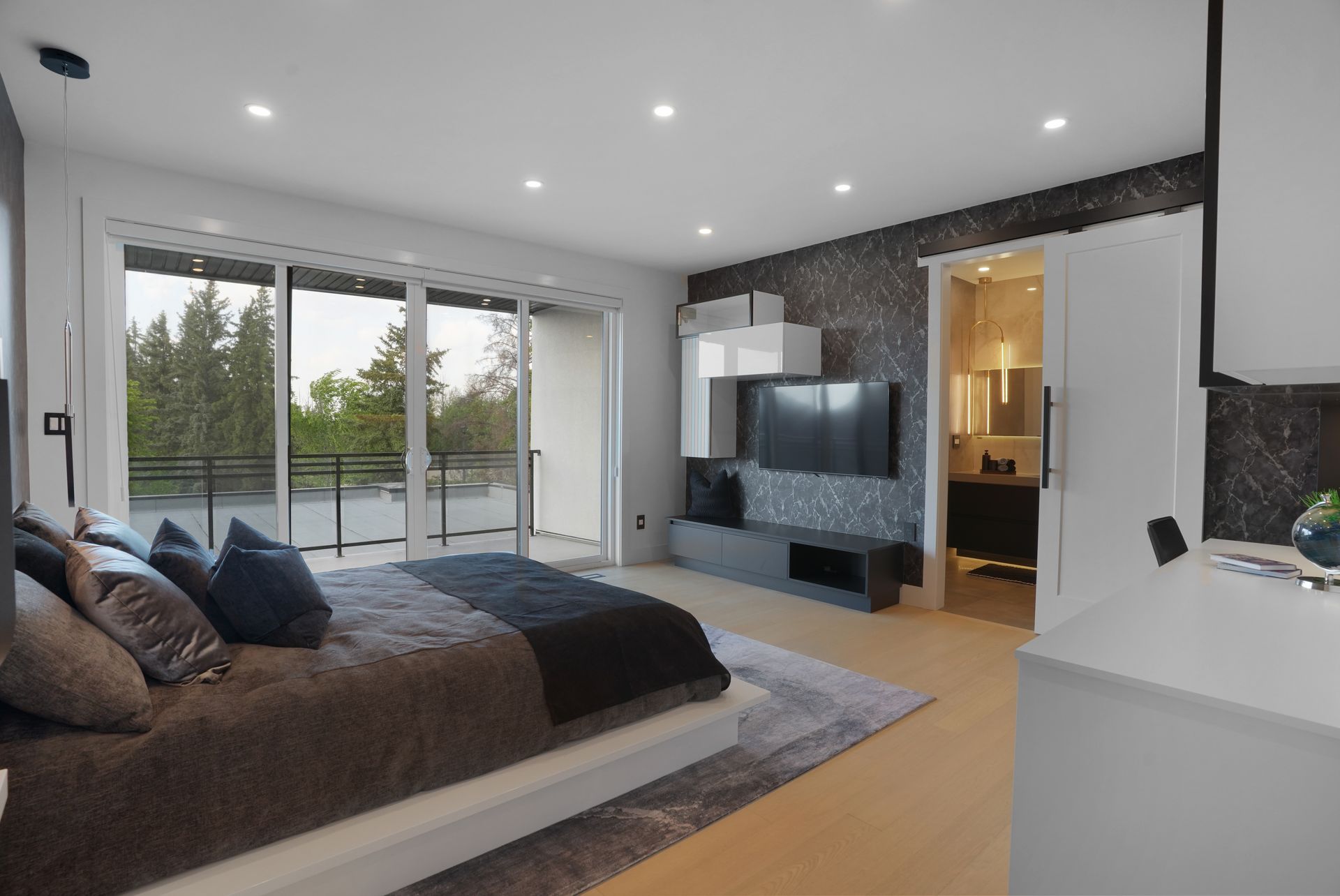 A bedroom with a large bed and a flat screen tv