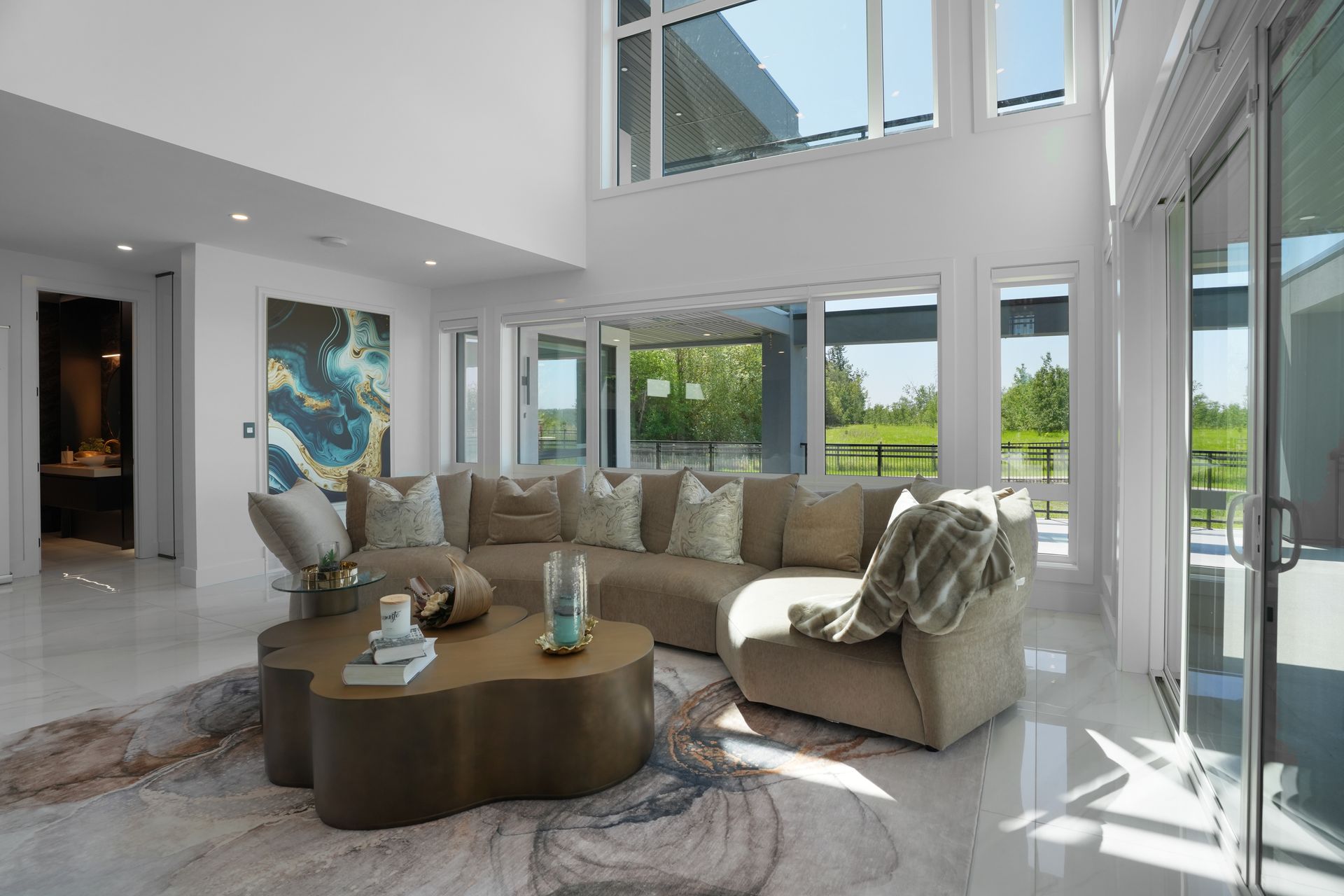 A living room with a large sectional couch and a coffee table.