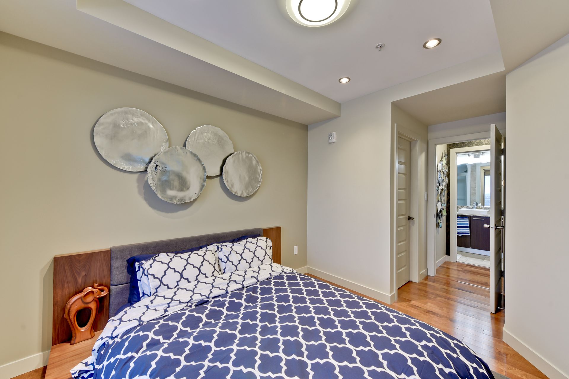 A bedroom with a bed and a mirror on the wall