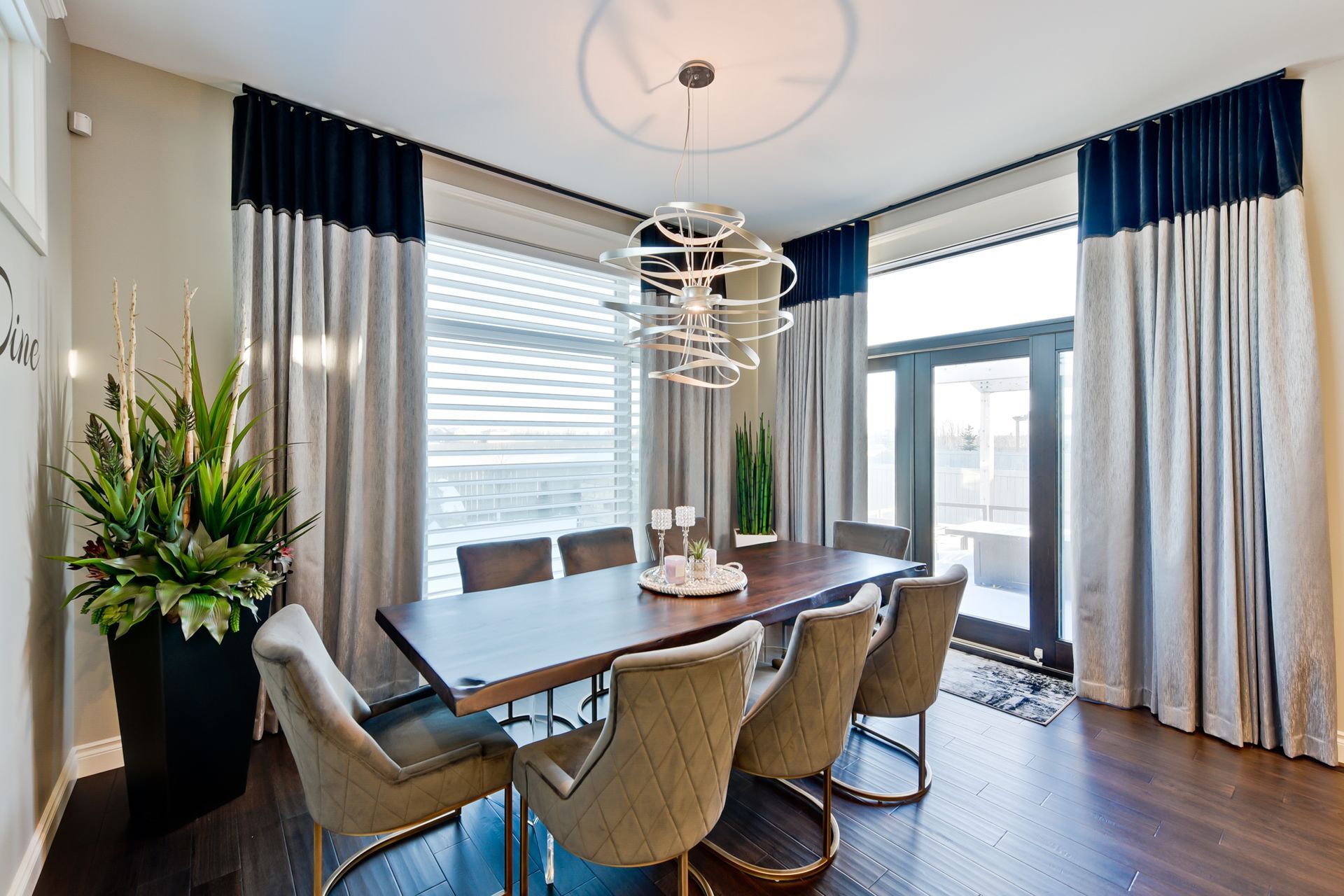A dining room with a table and chairs and a chandelier