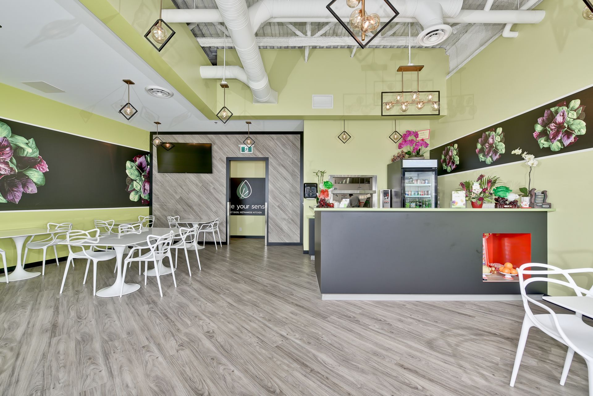 A restaurant with tables and chairs and a counter.