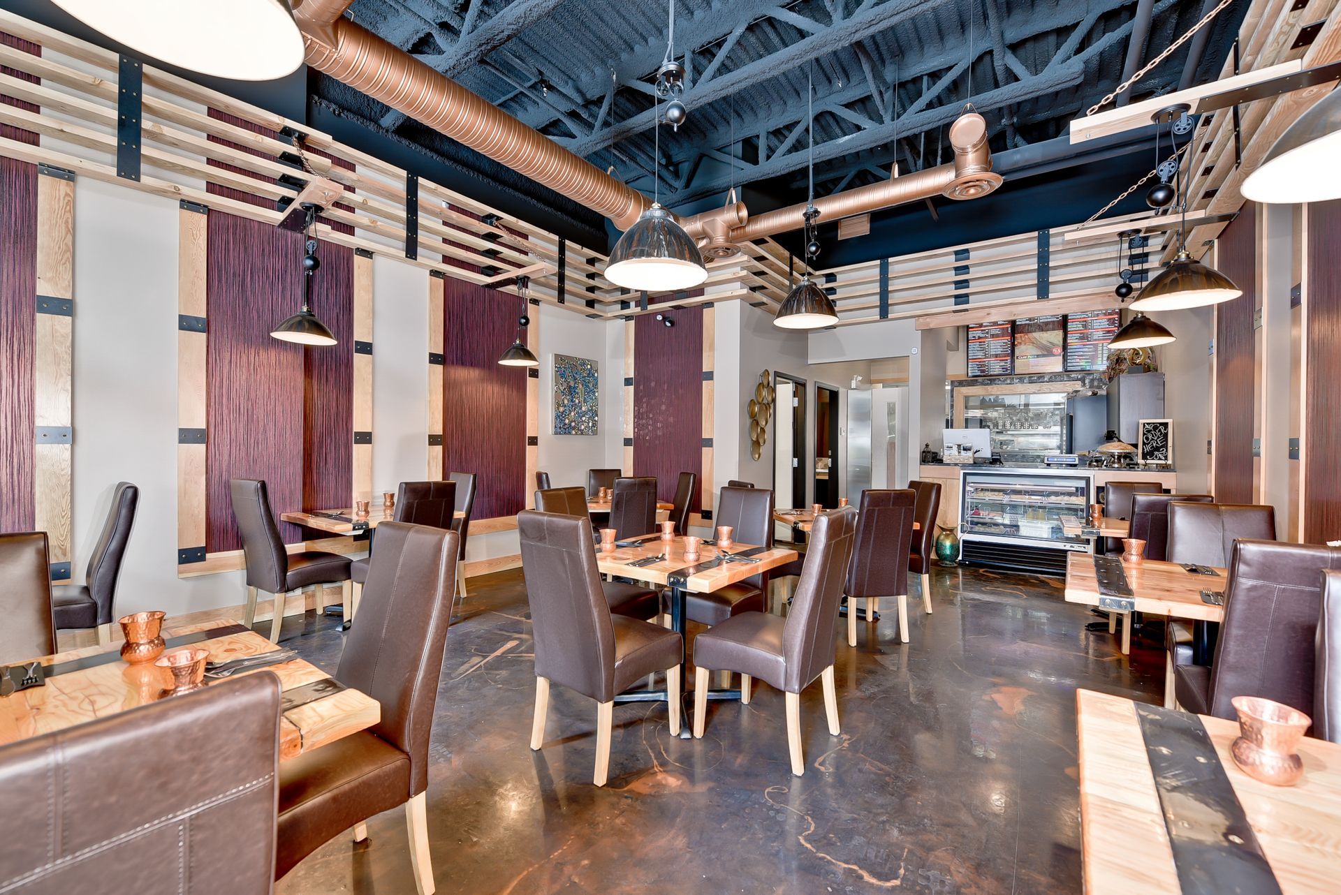 A large dining room with tables and chairs in a restaurant.