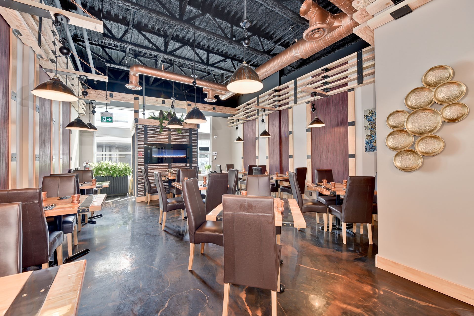 A large dining room with tables and chairs in a restaurant