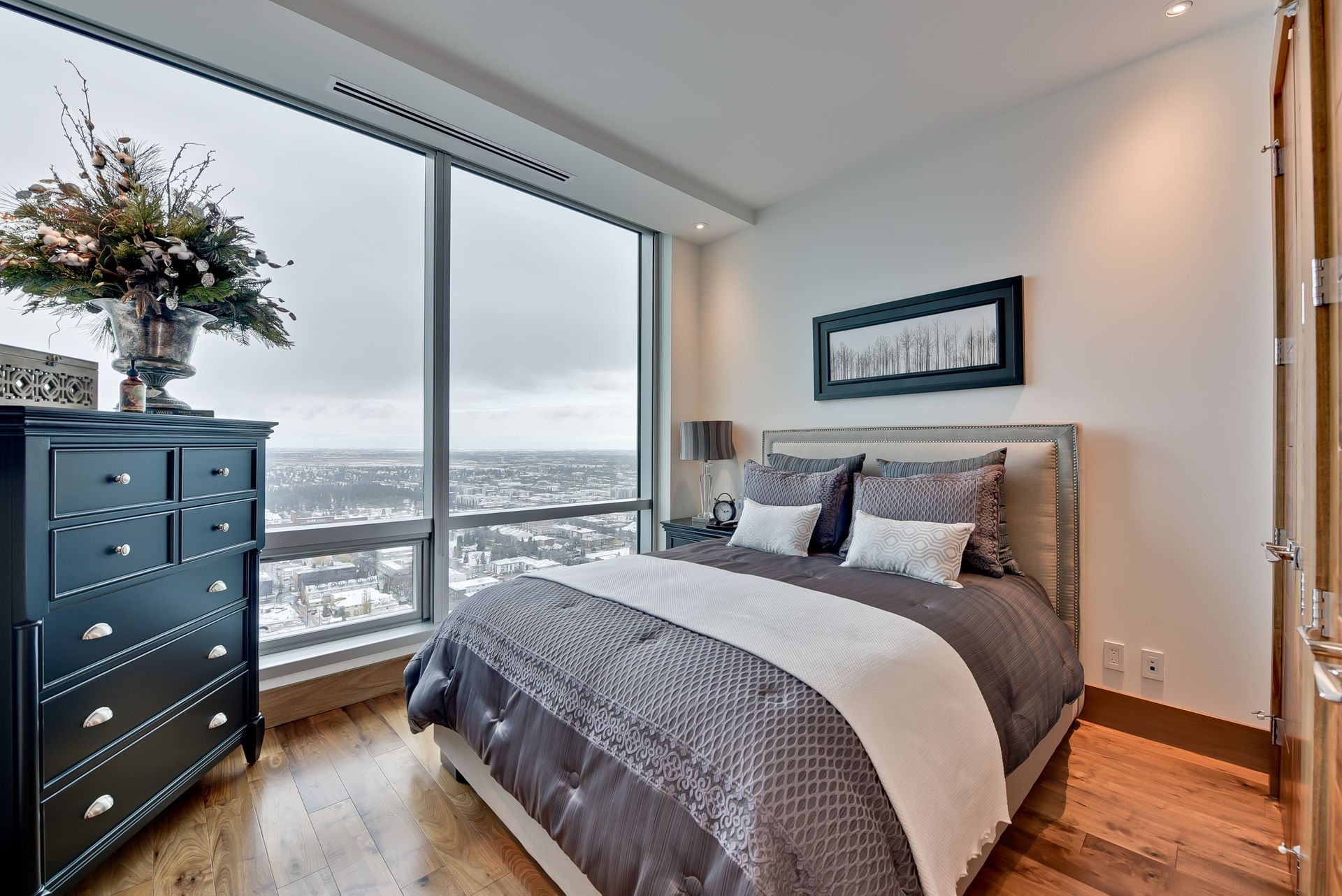 A bedroom with a large bed and a large window