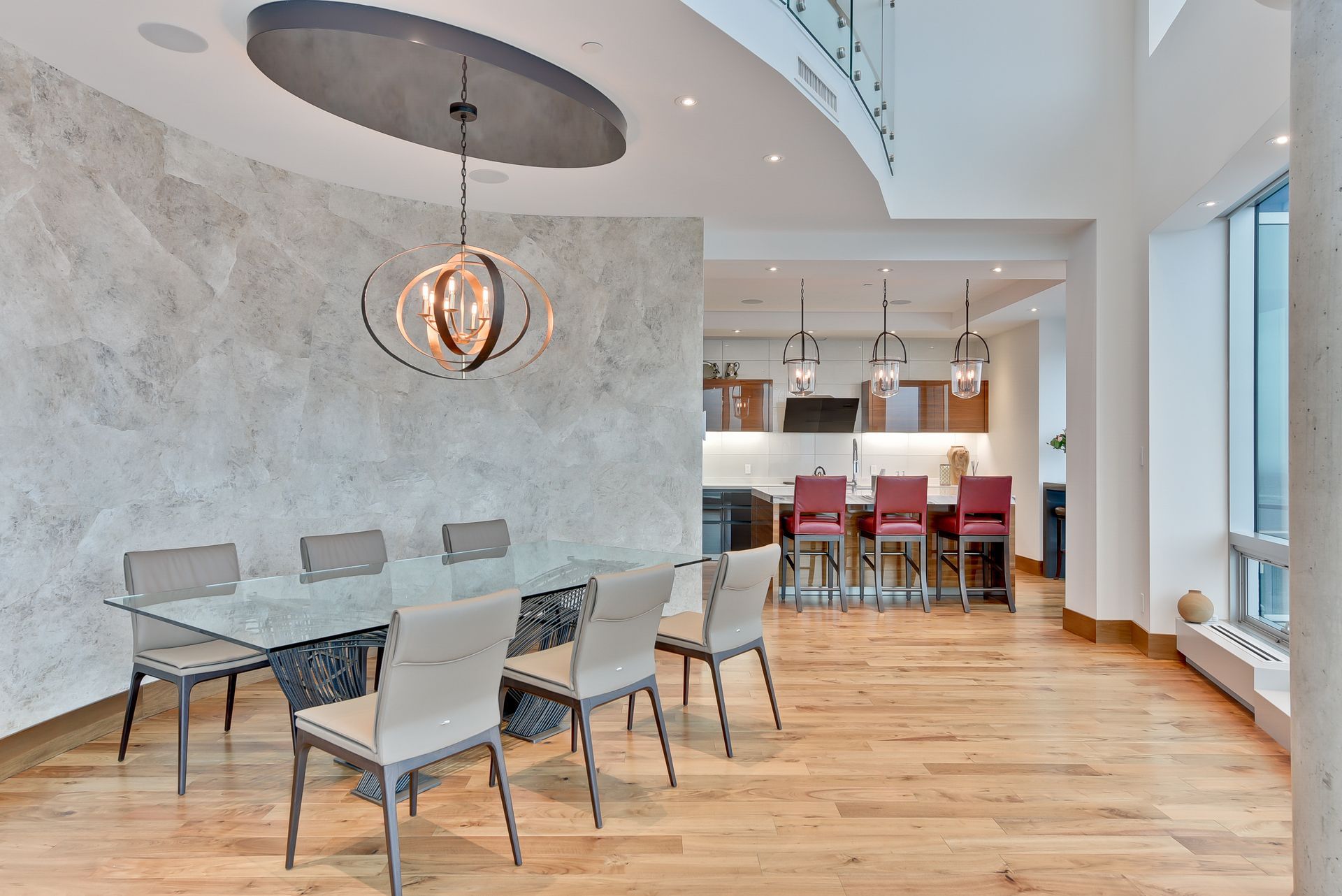 A dining room with a glass table and chairs