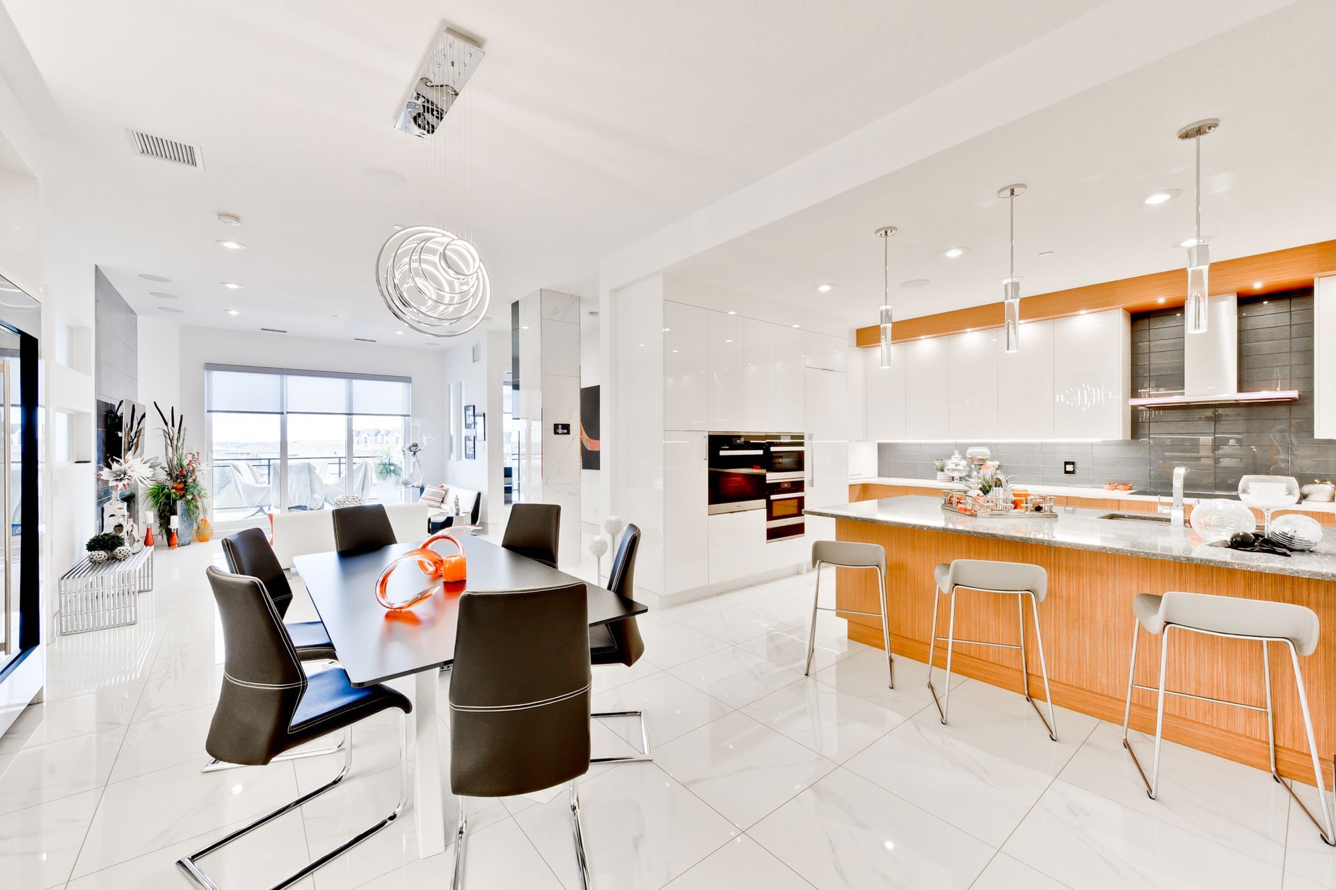 There is a dining table and chairs in the middle of the kitchen.