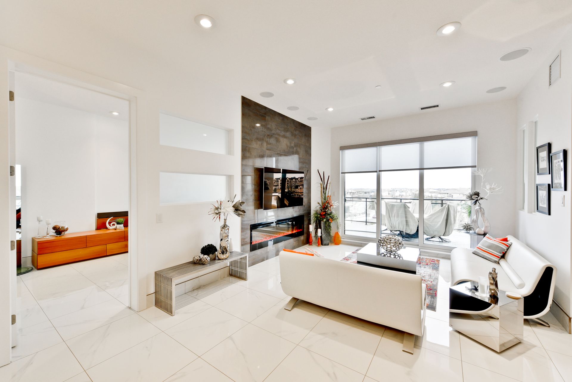 A living room with a white couch and a fireplace