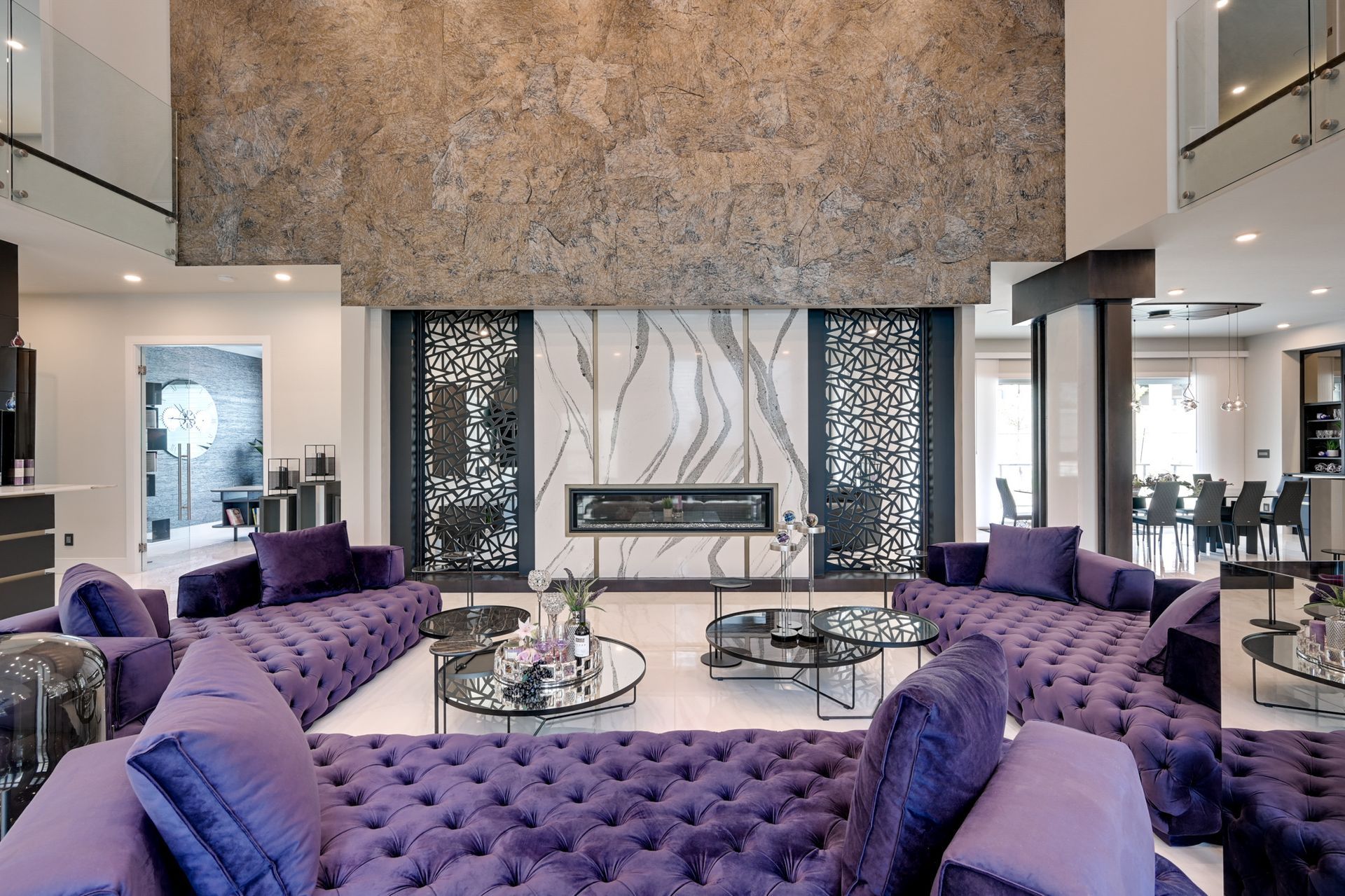 A living room with purple furniture and a fireplace