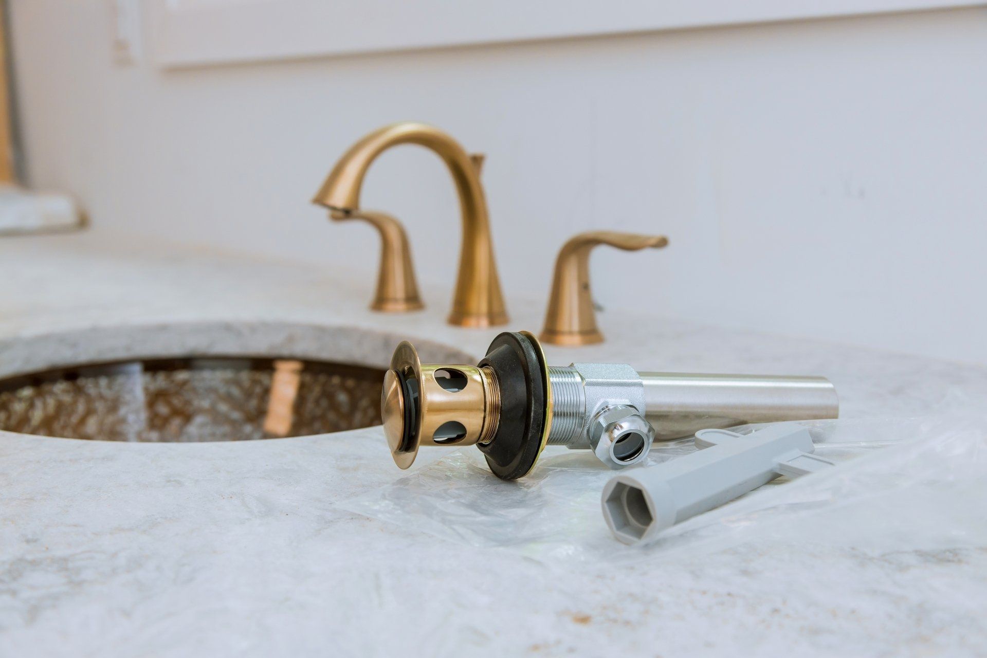 A bathroom sink with a drain and faucet on the counter.