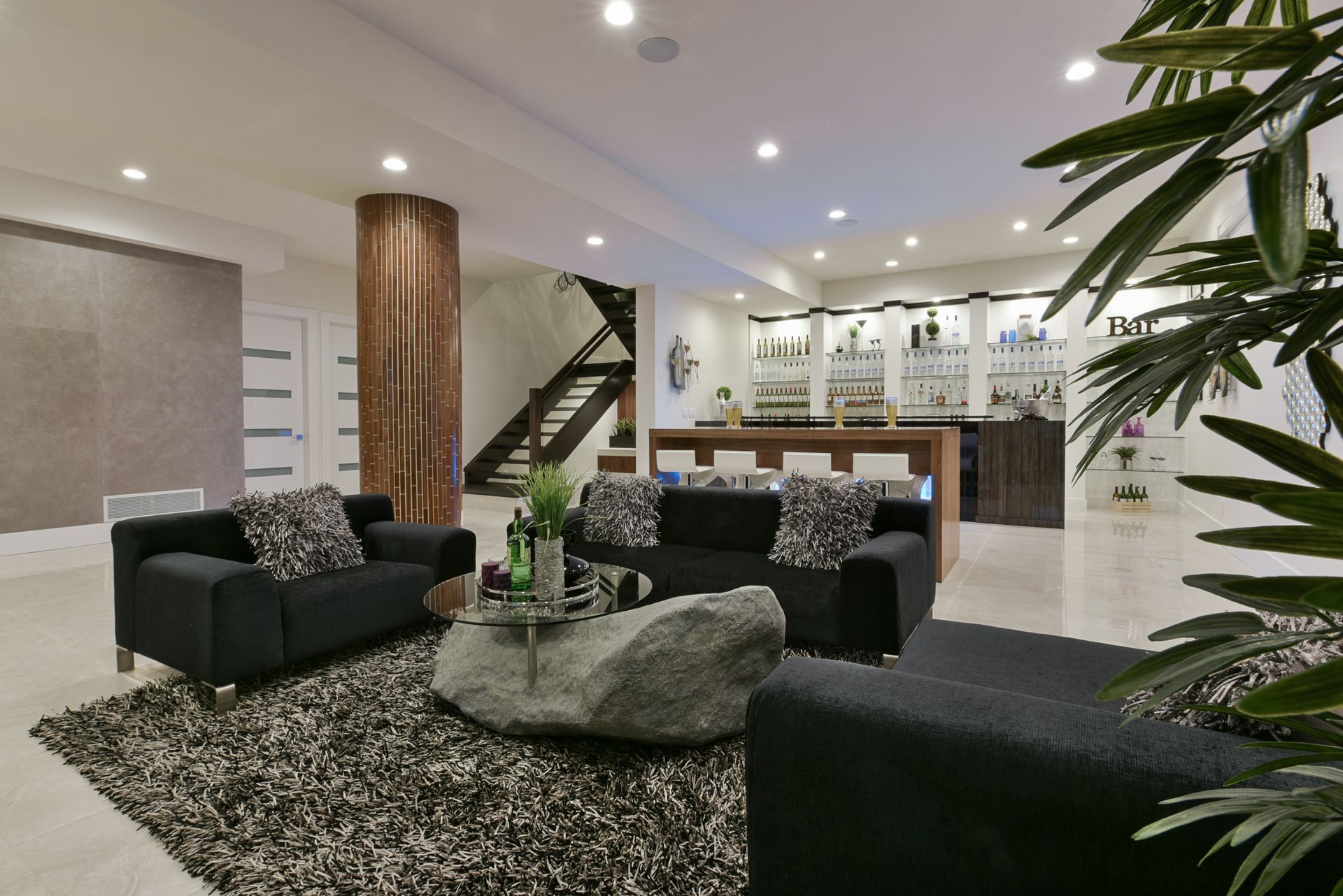 A living room with a couch and two chairs